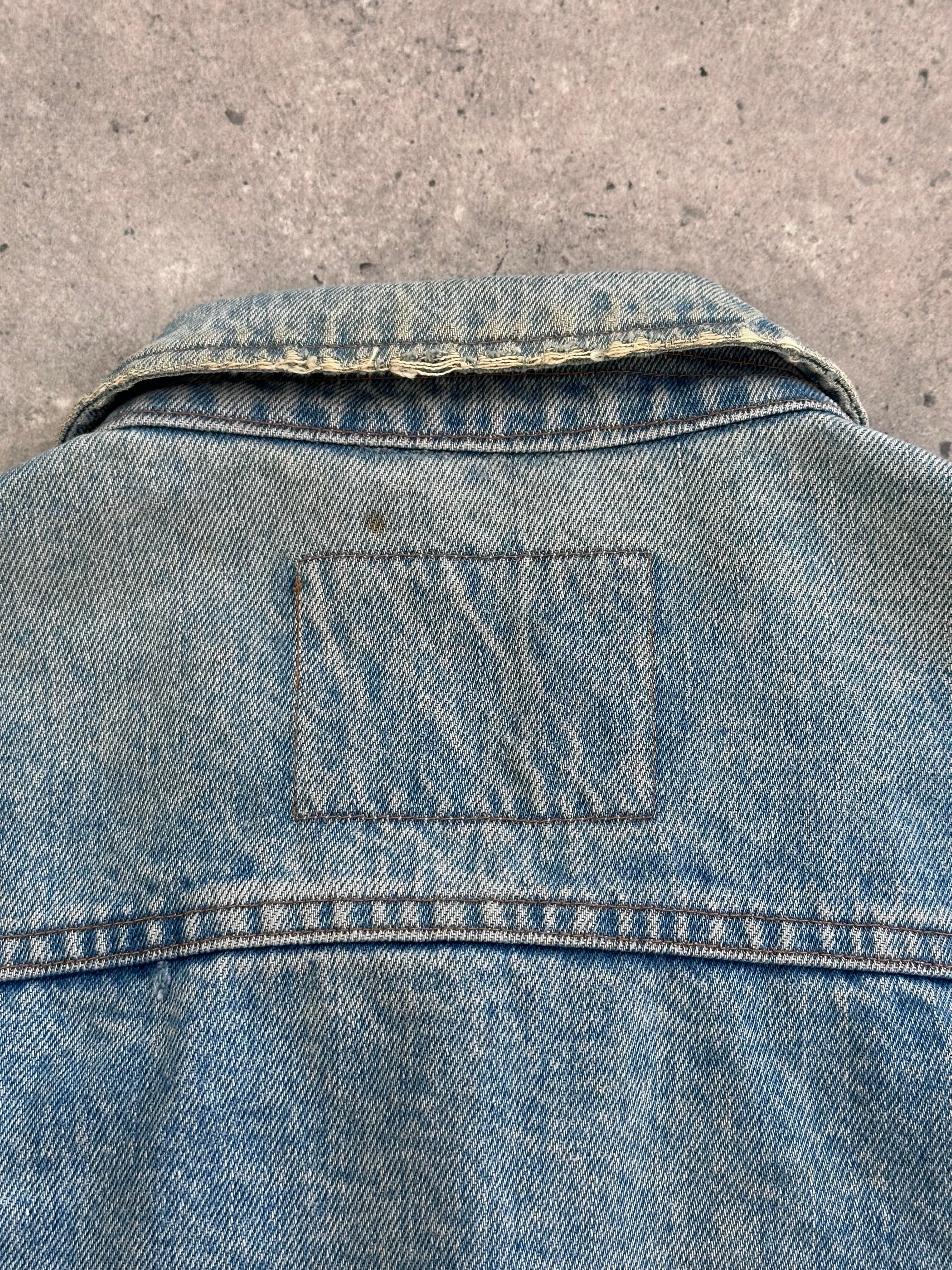 Valentino denim jacket in XL size displayed on hanger, featuring classic blue denim with contrast stitching and button closure.