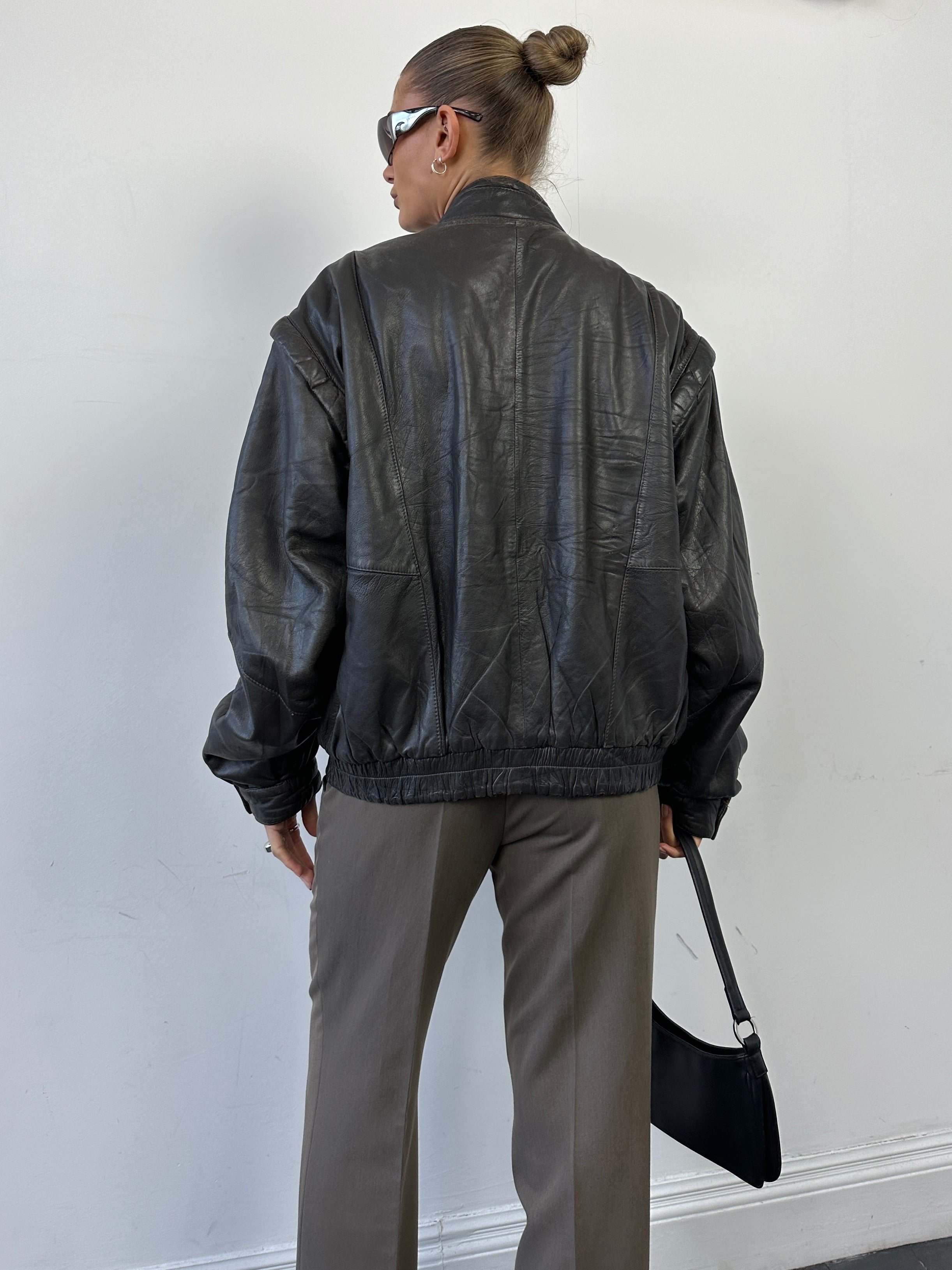 Vintage leather bomber gilet jacket in size M, featuring a classic distressed leather look and a sleeveless design with front pockets.