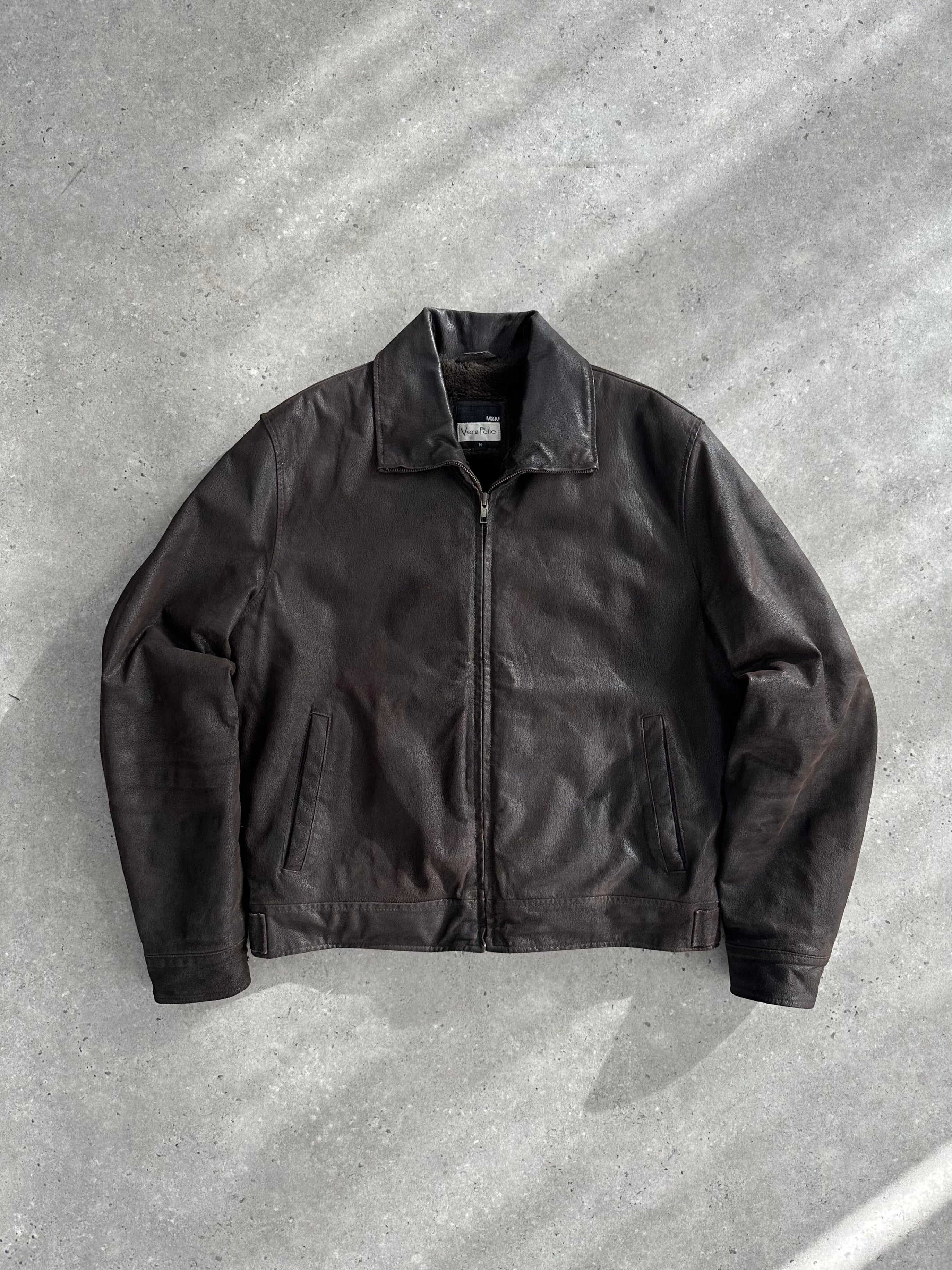 Vintage fur-lined leather jacket in size M/L, featuring a classic style with warm fur collar and durable leather construction.