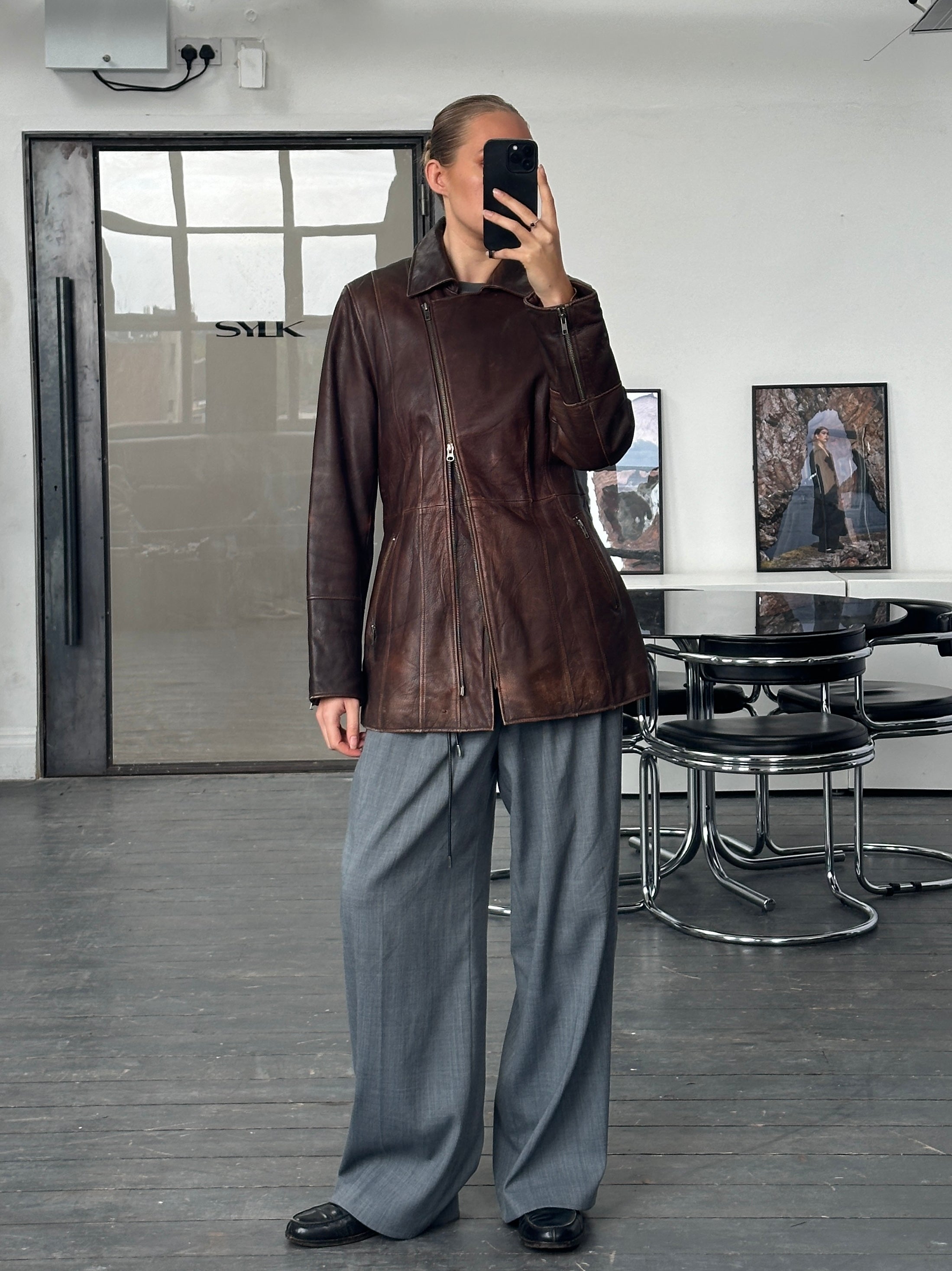 Vintage 1990s aged double zip leather jacket with belted waist, featuring a rugged, distressed leather look and classic style.