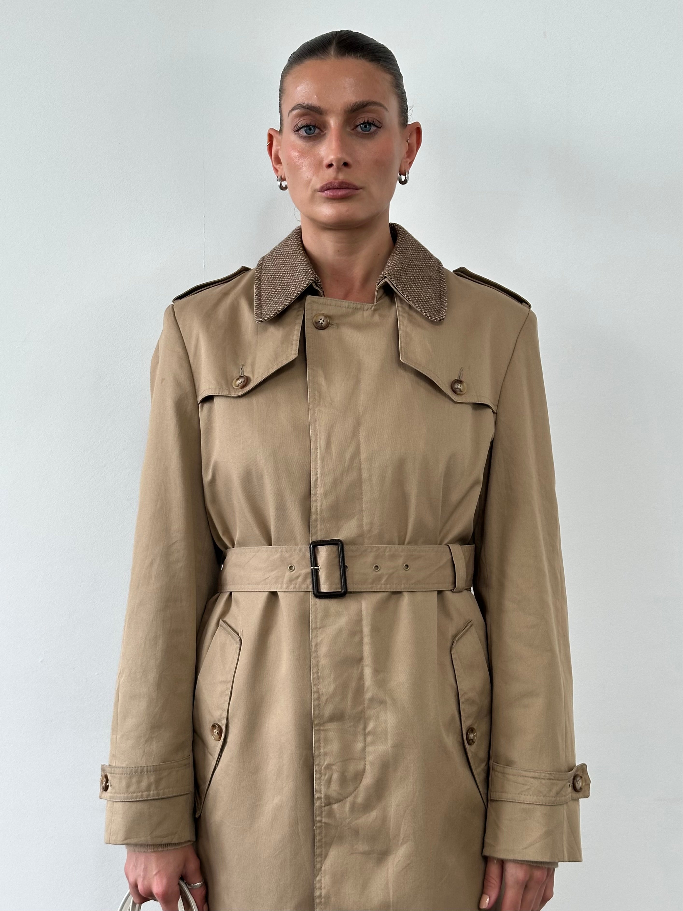 Christian Dior Monsieur cotton belted single-breasted trench coat displayed on a hanger, showcasing classic design and neutral color.
