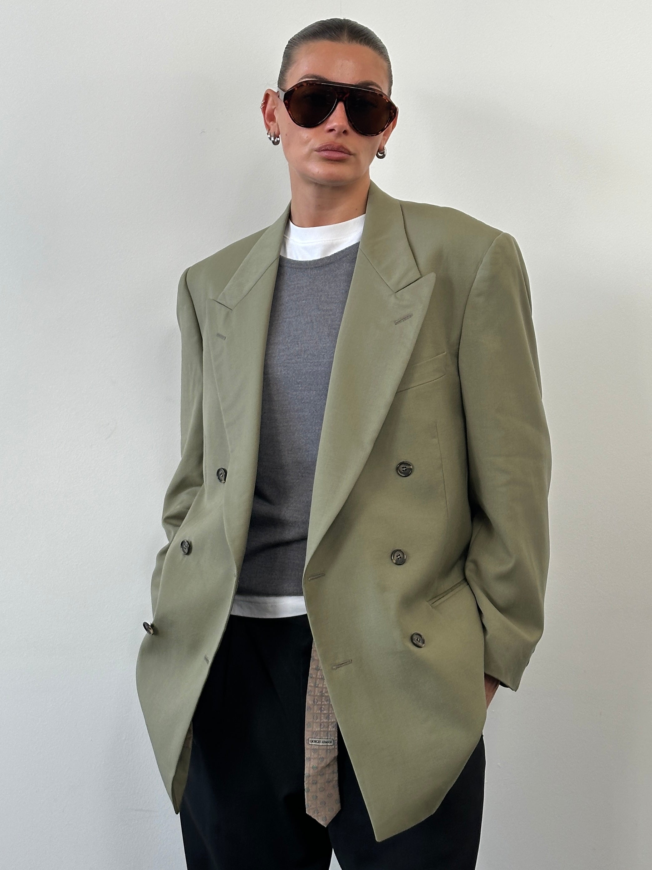 Yves Saint Laurent 1980s pure wool double-breasted blazer in size 40R/L, tailored fit, classic dark color, detailed lapels and buttons