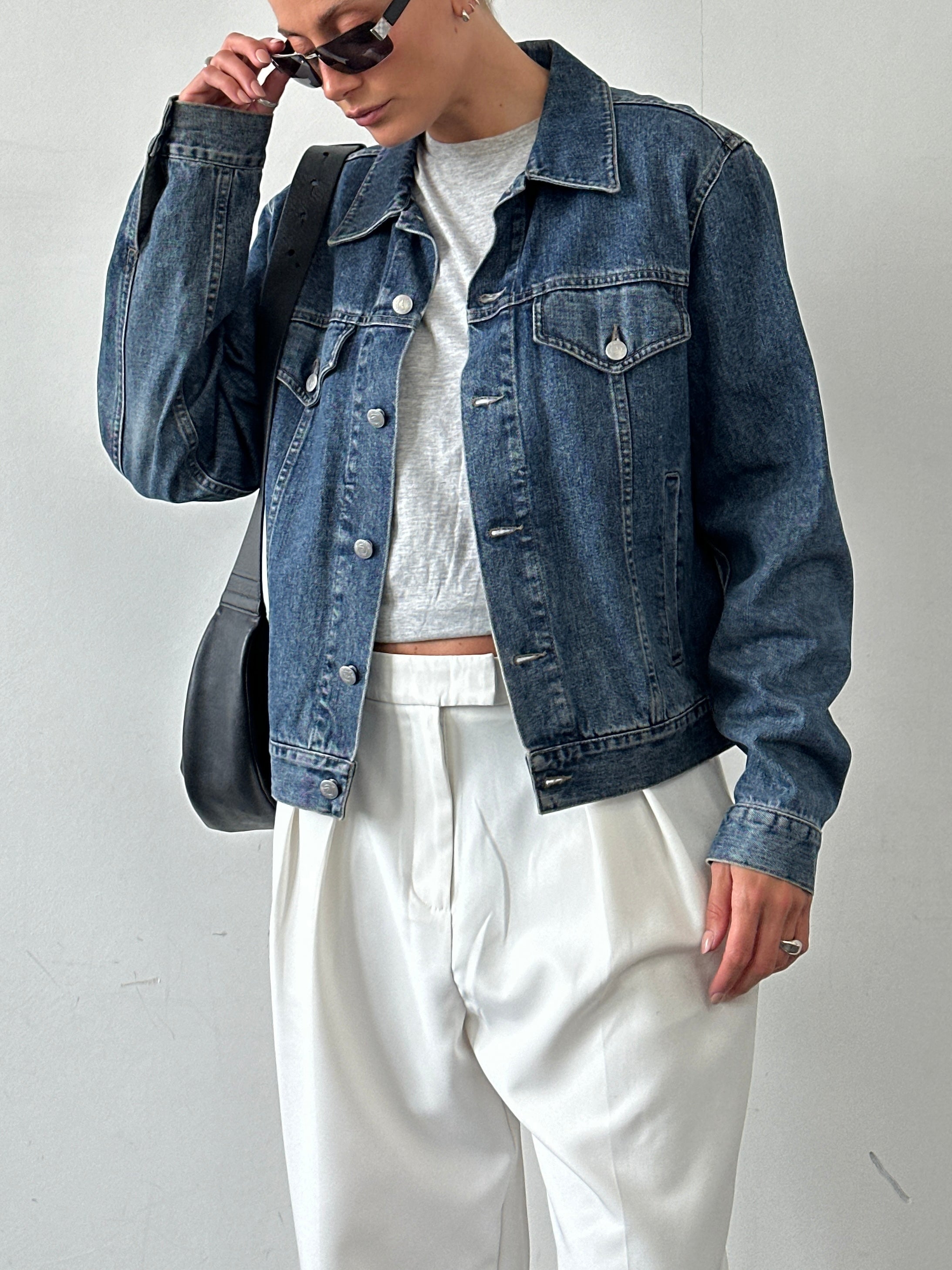 Armani Jeans denim jacket in size M, featuring classic blue denim fabric with button closure and chest pockets.