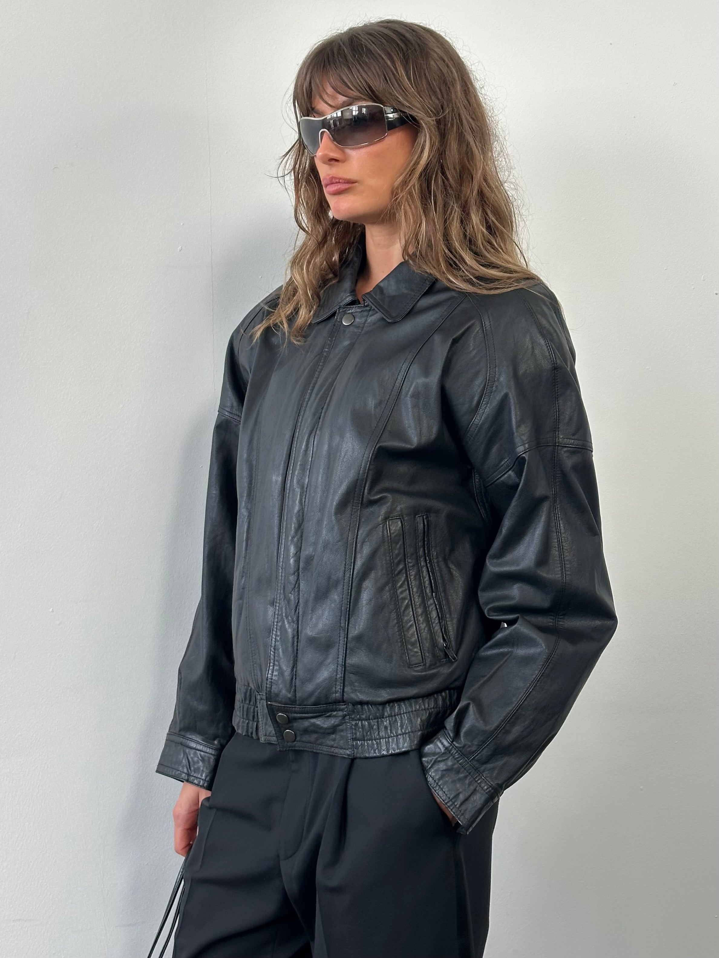 Vintage 1990s leather bomber jacket in medium size, featuring classic design and authentic leather material.