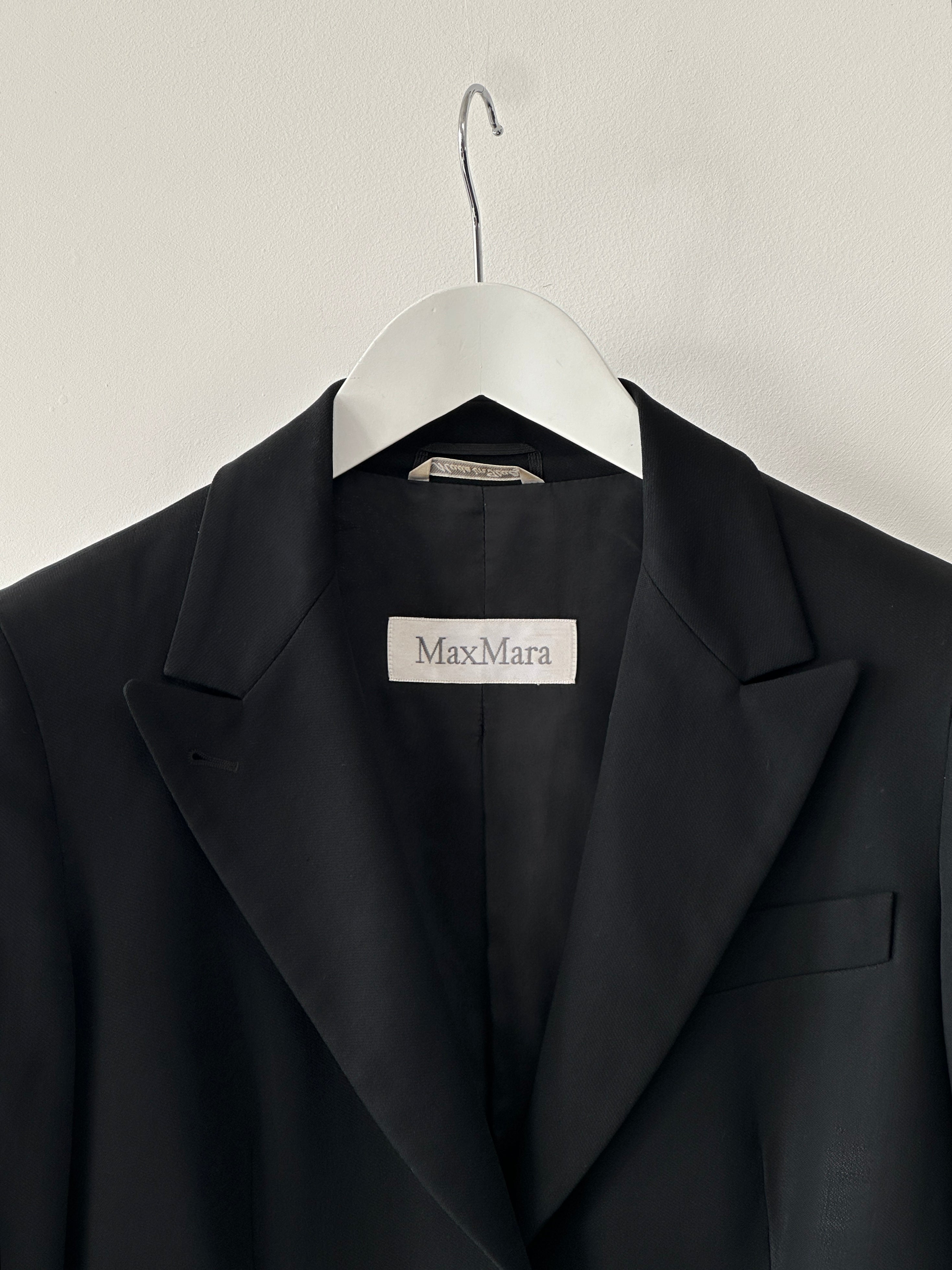 Max Mara pure wool fitted blazer in XS/S, tailored with a sleek design, displayed on a hanger against a neutral background.