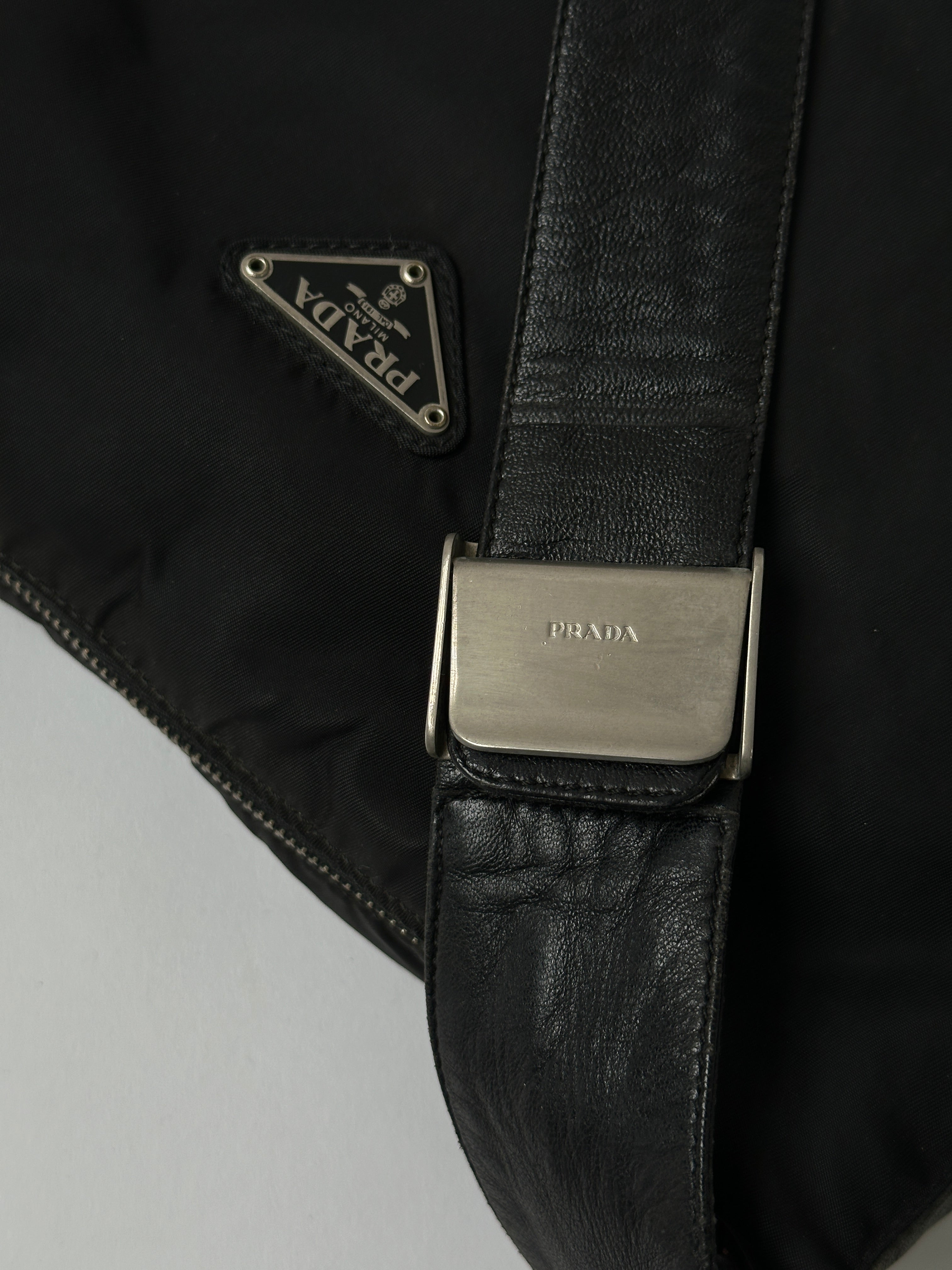 Prada nylon and leather crossbody bag with adjustable strap and sleek design, ideal for everyday use.