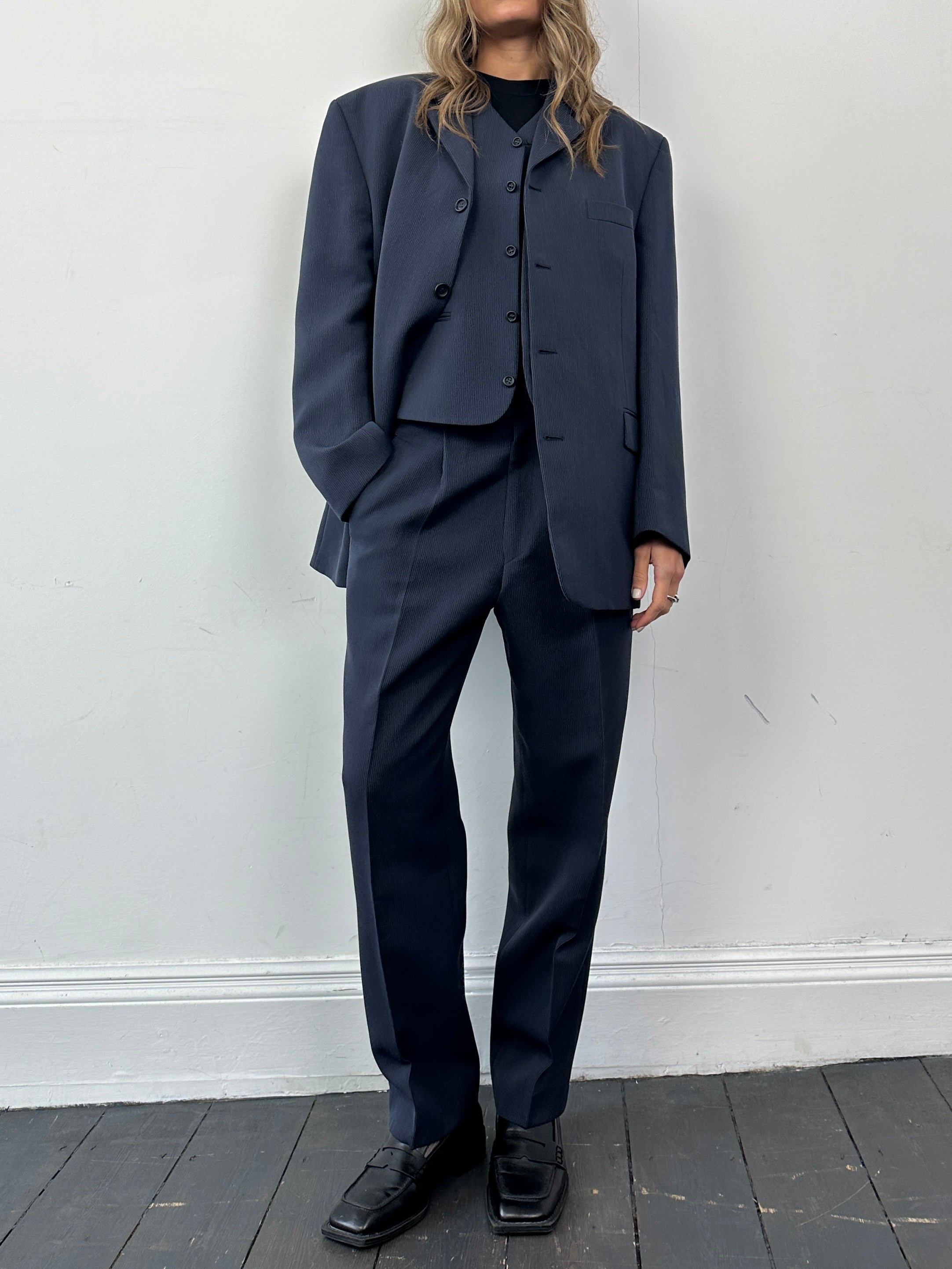 Vintage wool blend three-piece suit in size 40R/W32, featuring tailored jacket, vest, and trousers on a hanger.