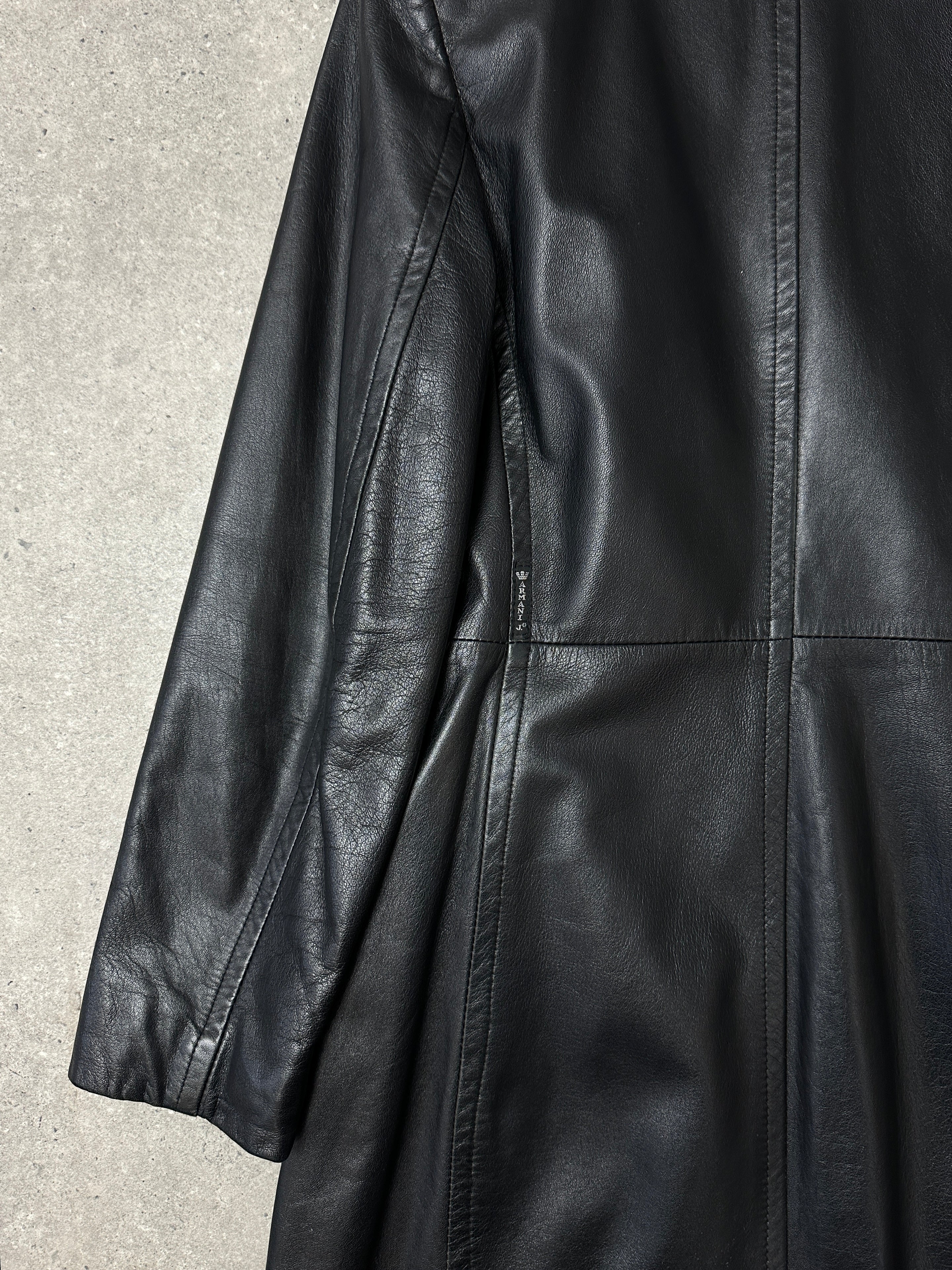 Armani leather trench coat in XS displayed on a hanger, showcasing its sleek design and high-quality leather material.