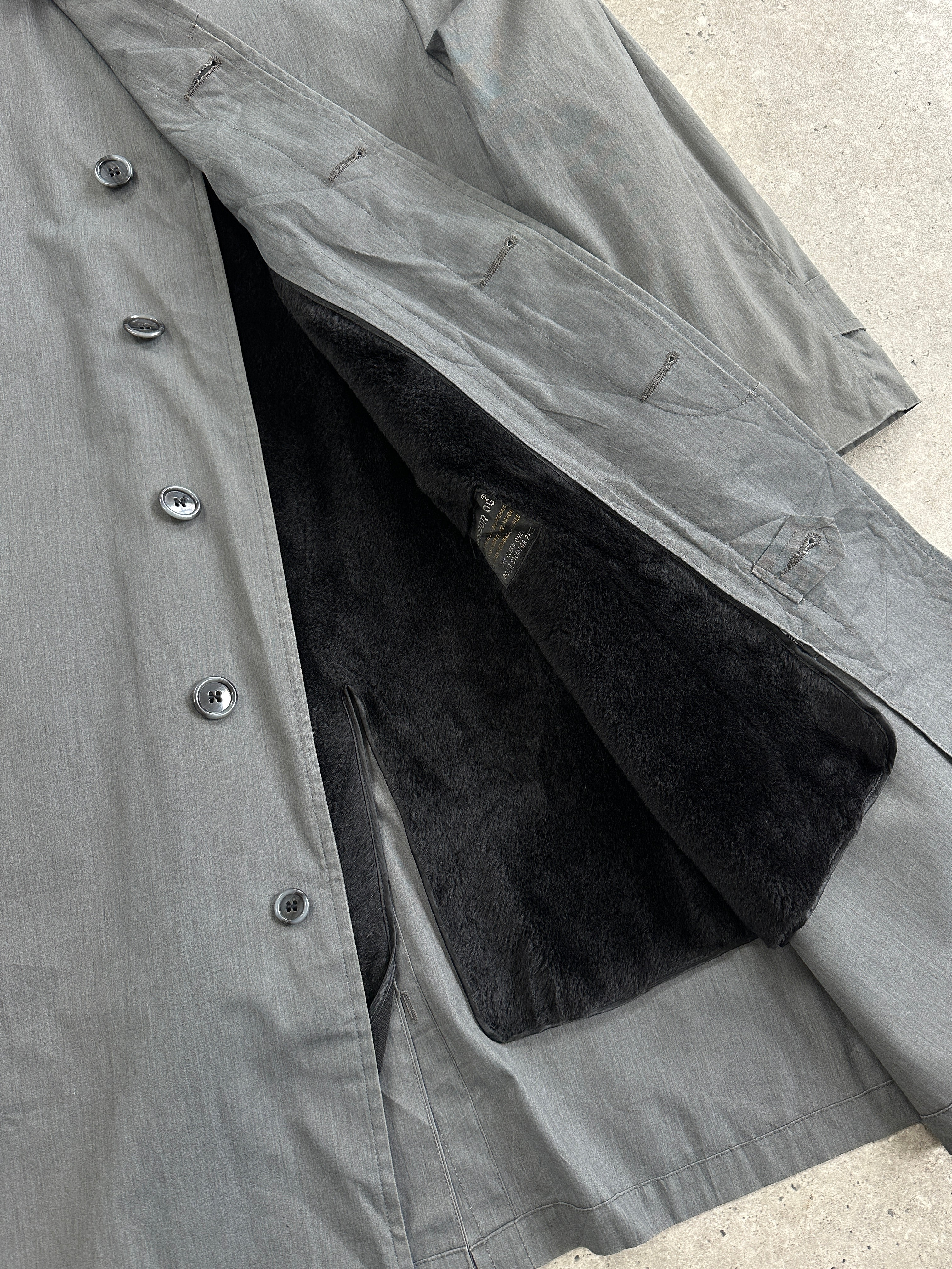 London Fog XL trench coat with concealed placket, classic beige color, shown hanging on a wooden coat rack.