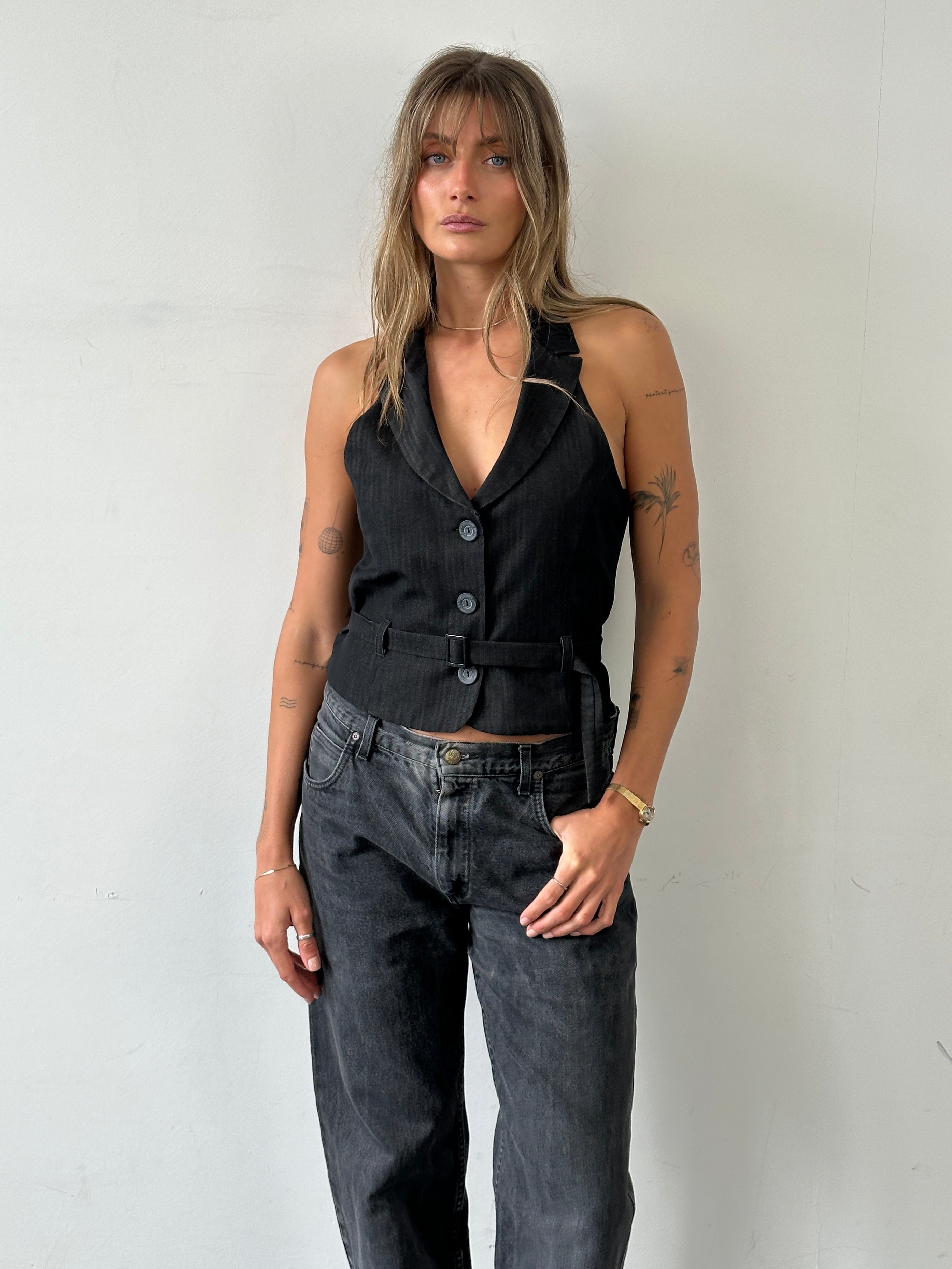 Vintage brand vintage halterneck belted waistcoat in size M, featuring classic design and tailored fit, displayed on a hanger.