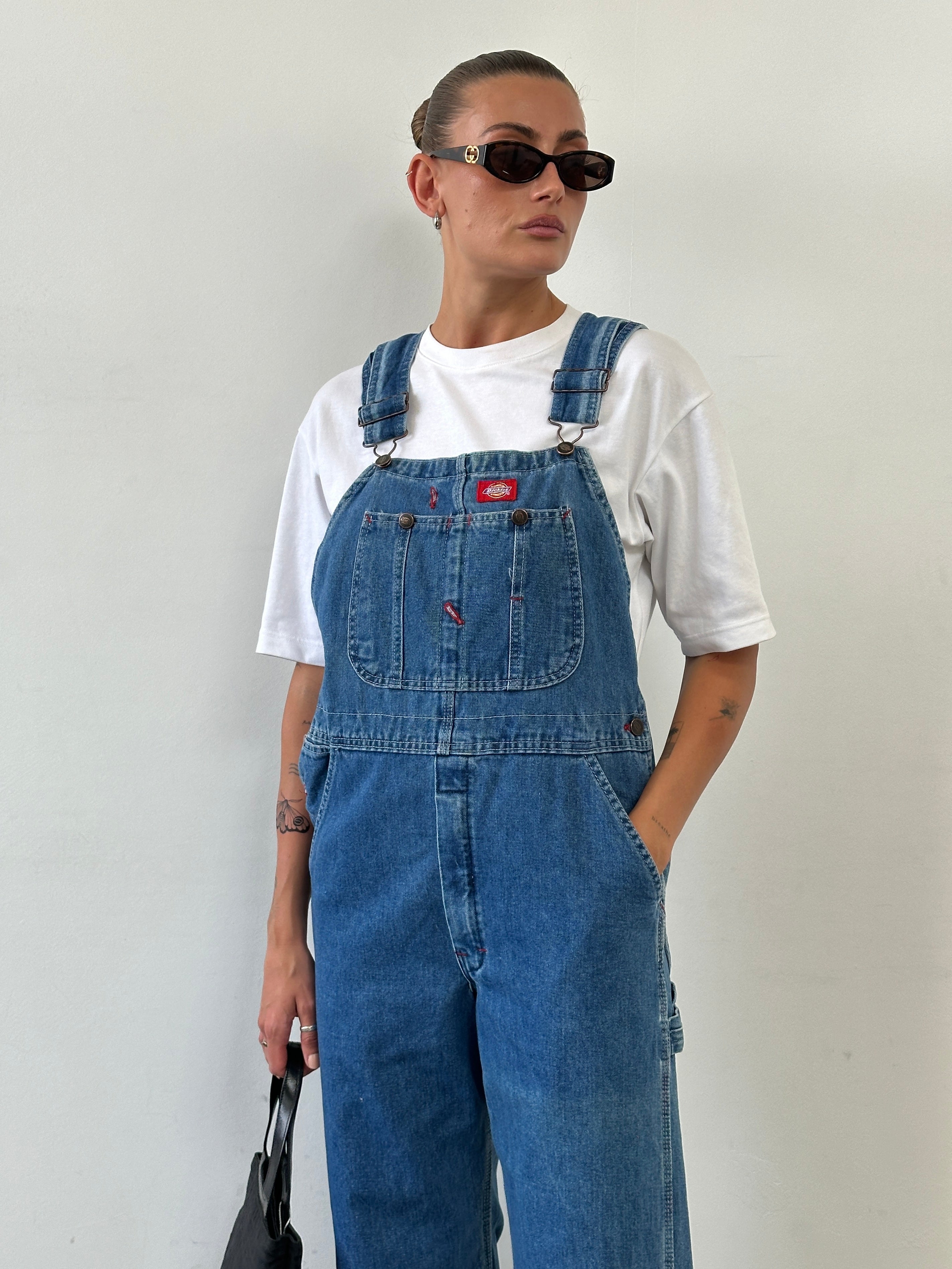 Dickies pure cotton denim dungarees in size M, showing the front view with adjustable shoulder straps and classic denim design.
