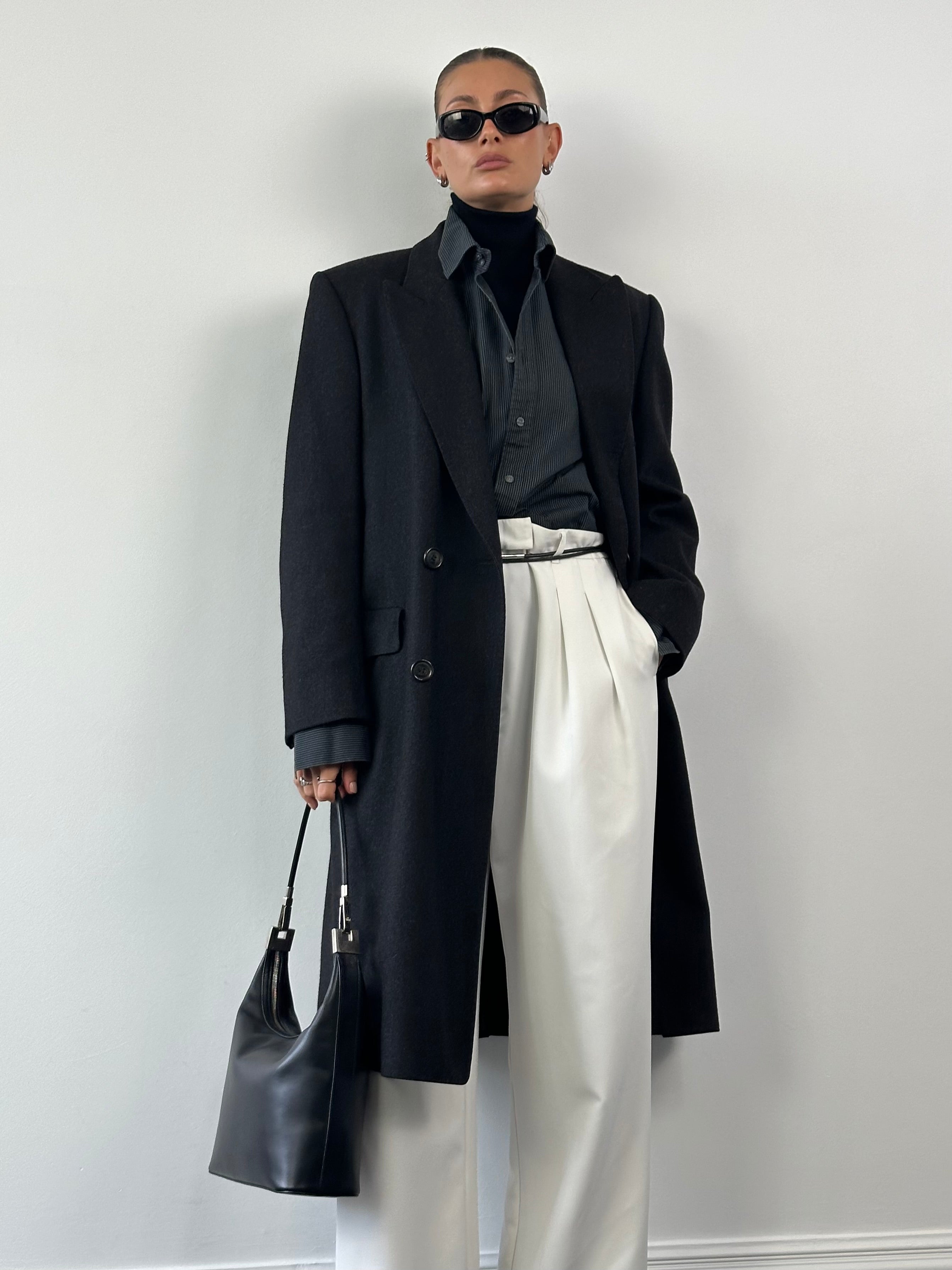 Christian Dior pure wool double-breasted coat in size L/XL, featuring classic design and tailored fit, displayed on a hanger.