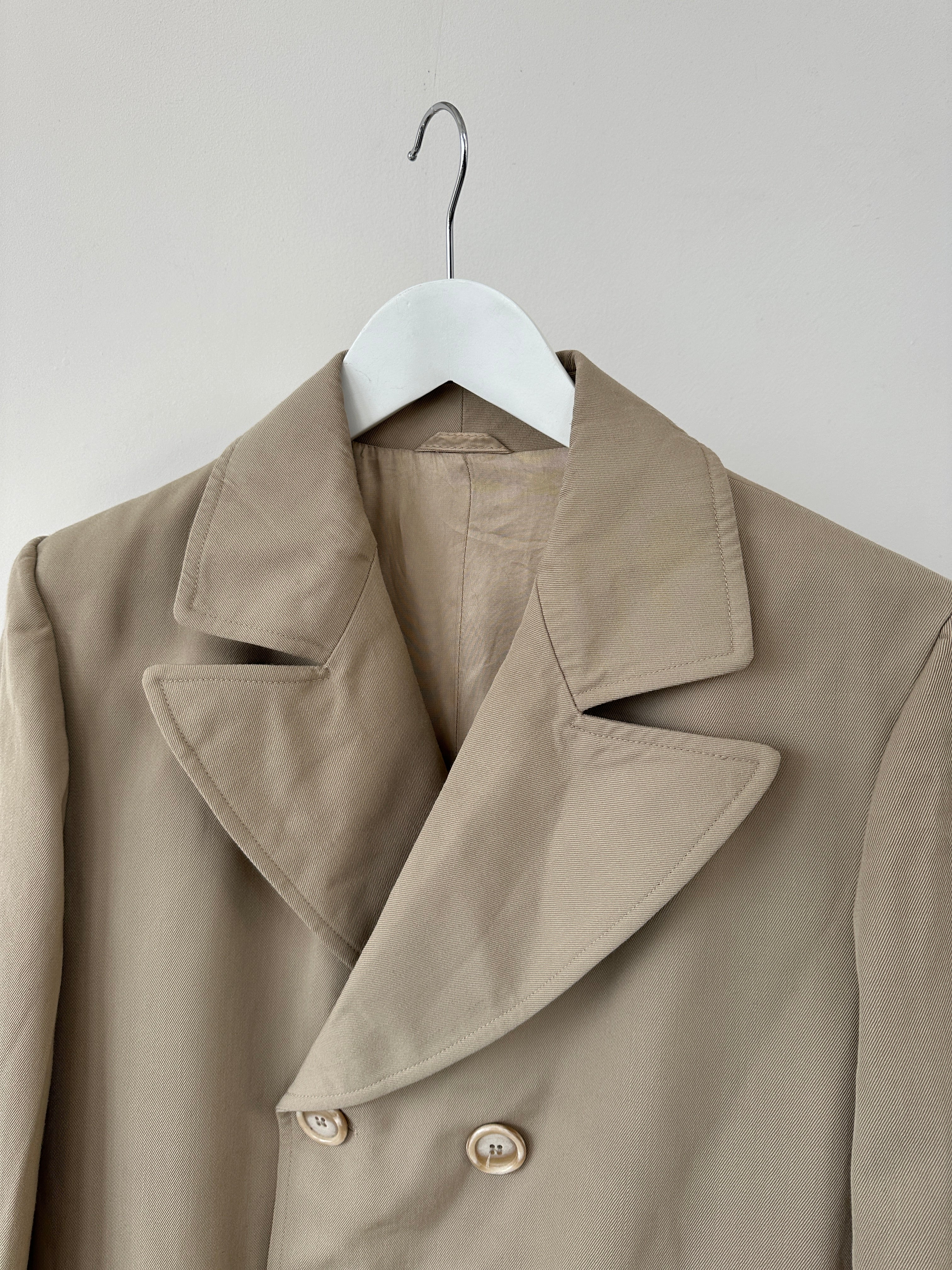 Vintage Italian double-breasted wool trench coat in classic design, shown in natural fabric texture and neutral color.
