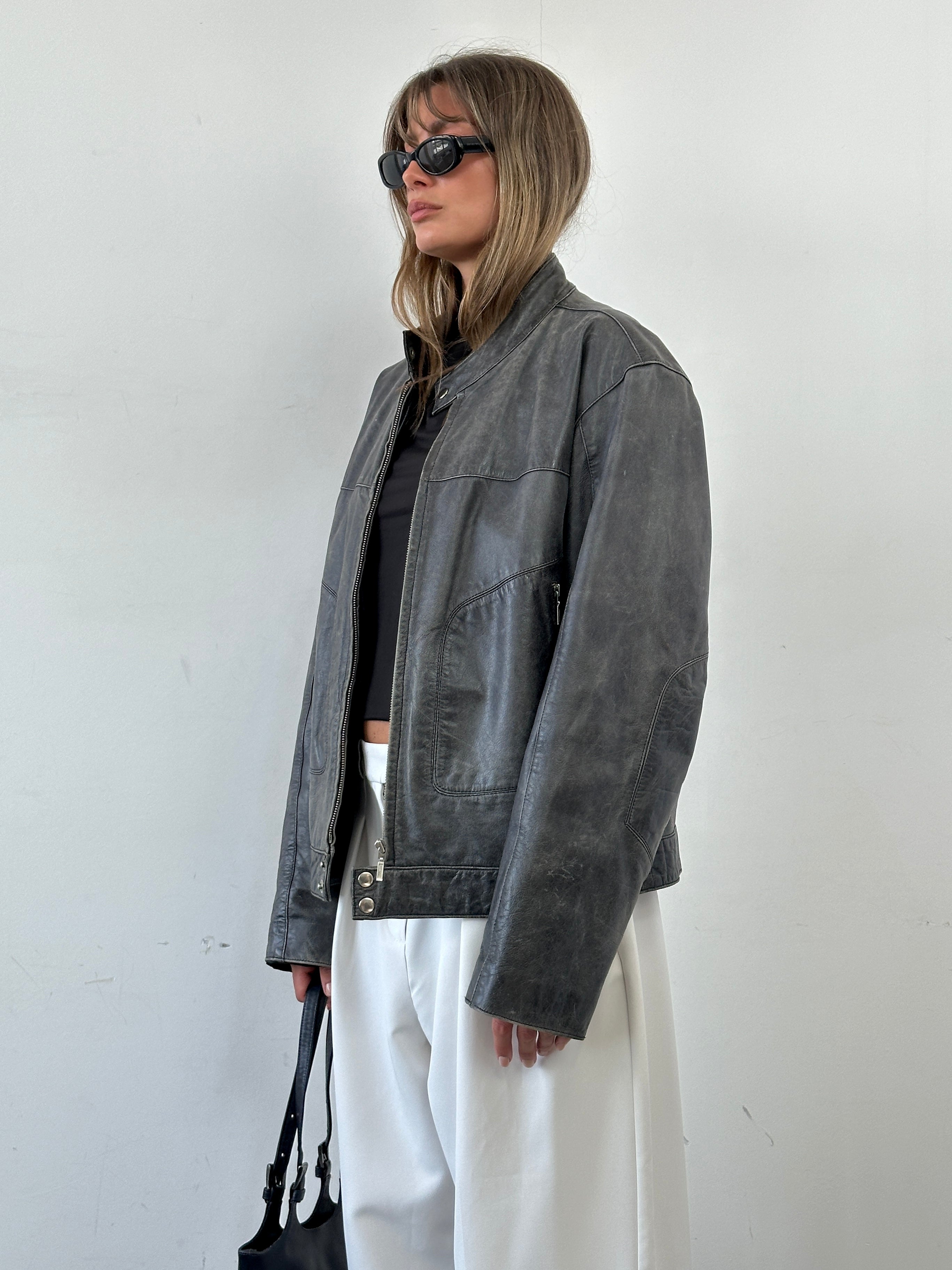 Vintage distressed leather moto jacket in size L/XL, featuring rugged style and classic motorcycle-inspired design.