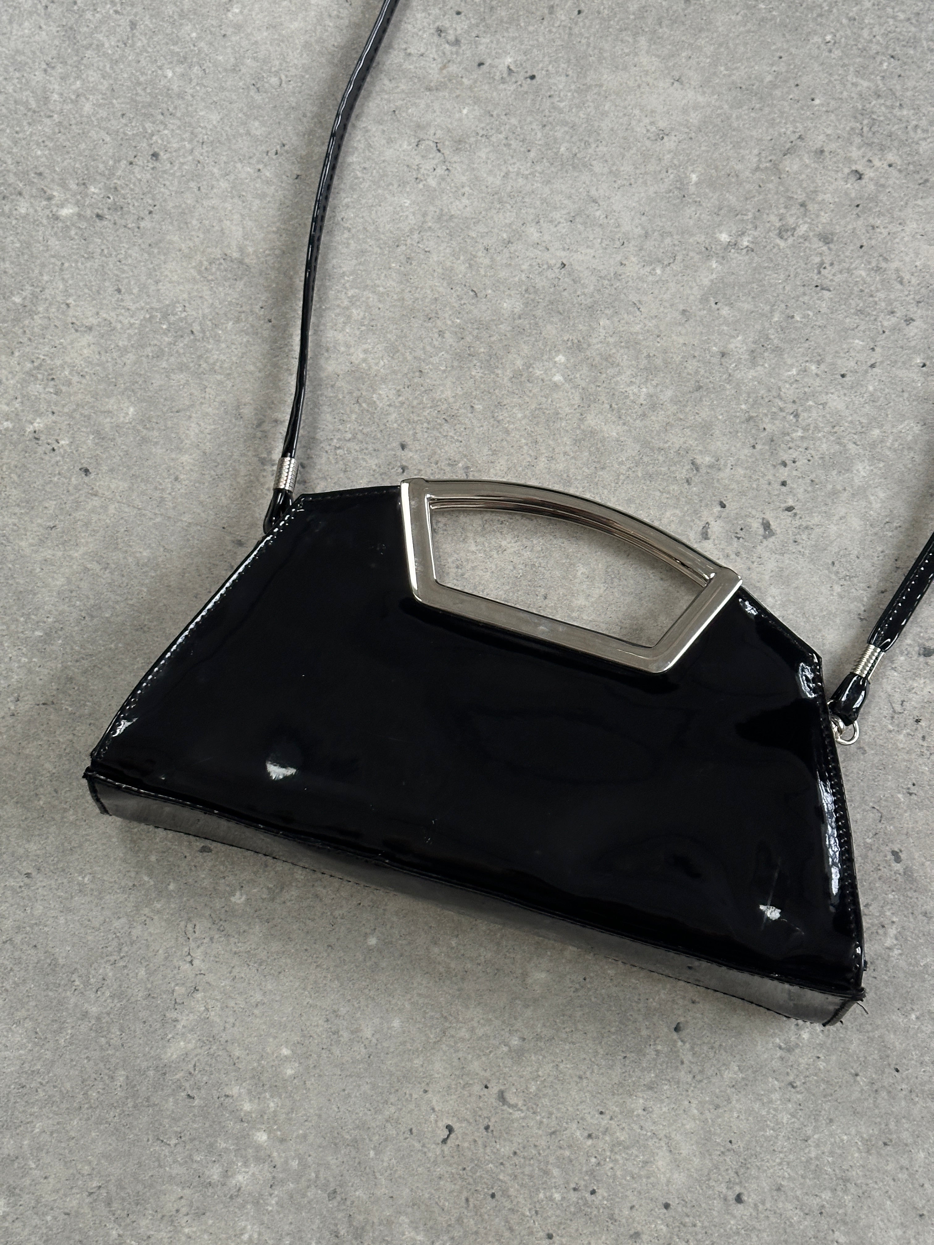 Vintage 2000s patent vinyl chrome crossbody clutch bag with sleek design and shiny finish, featuring a compact and stylish look.