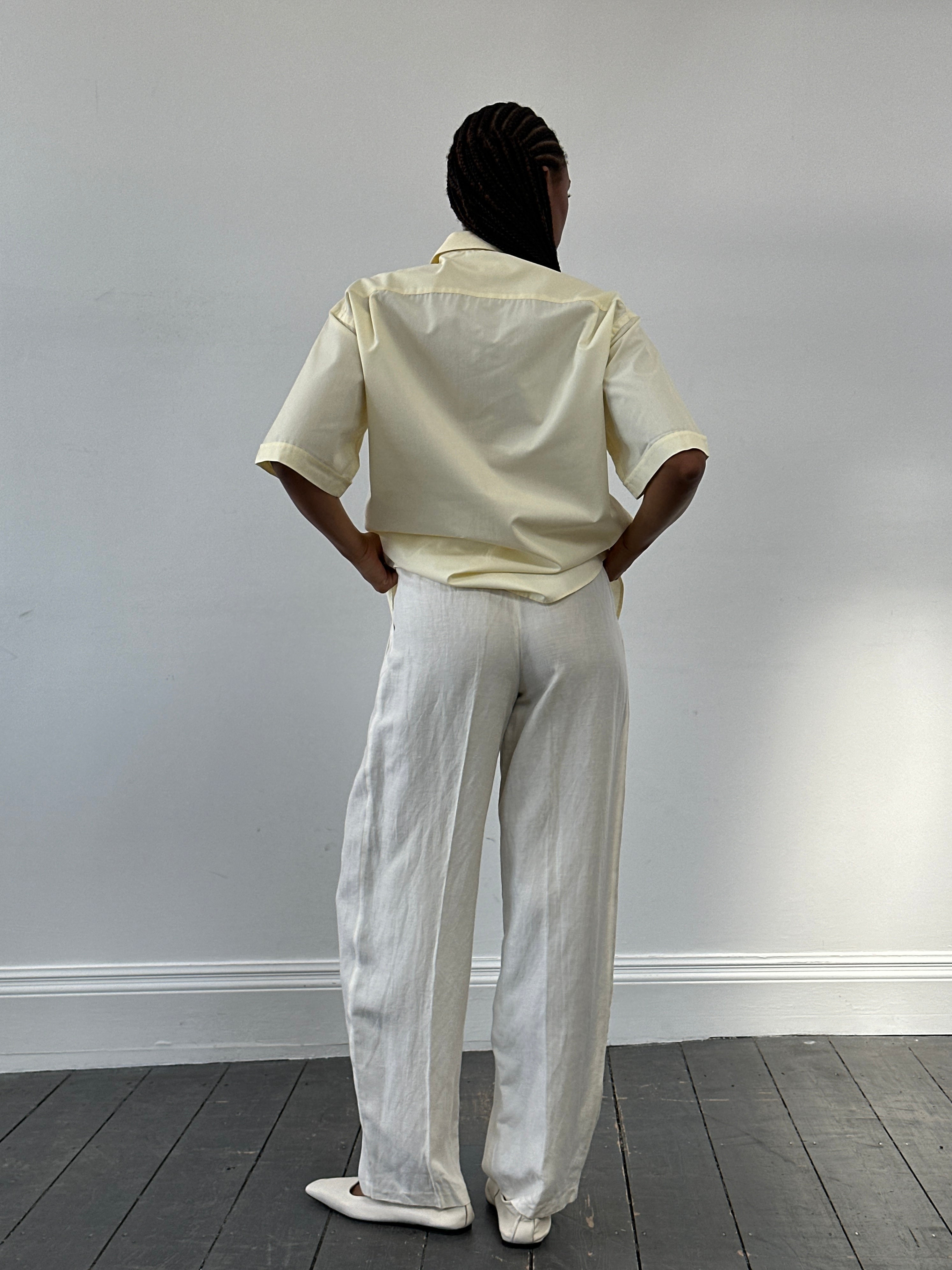 Versace 1980s high-waisted silk linen trousers in W22, showing the tailored fit and luxurious fabric details.