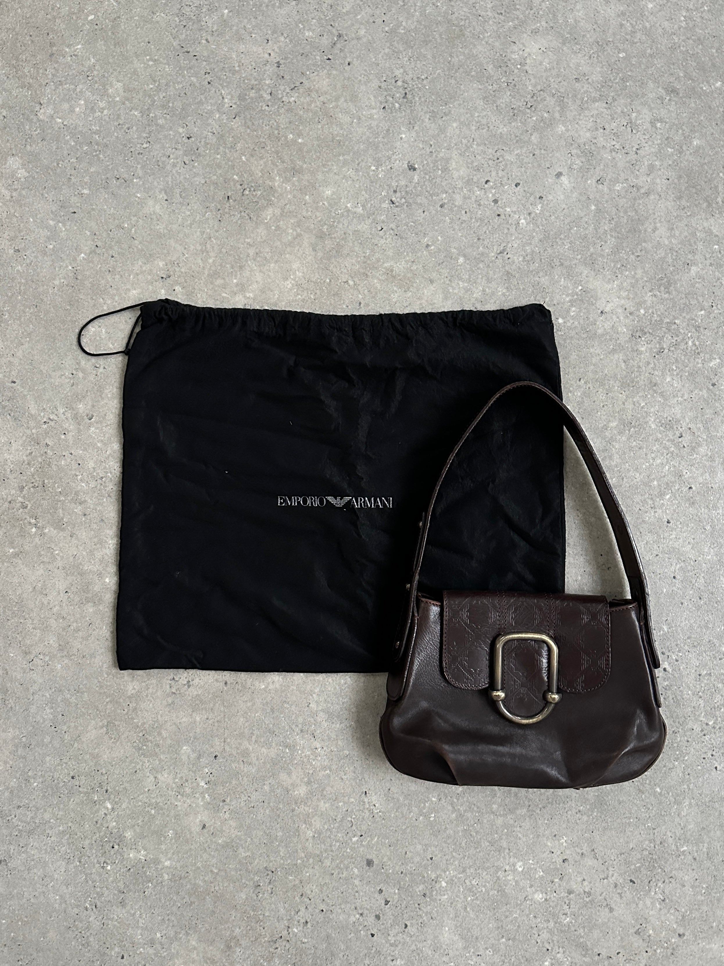 Emporio Armani leather shoulder bag with hardware monogram, featuring sleek design and adjustable strap for everyday style.