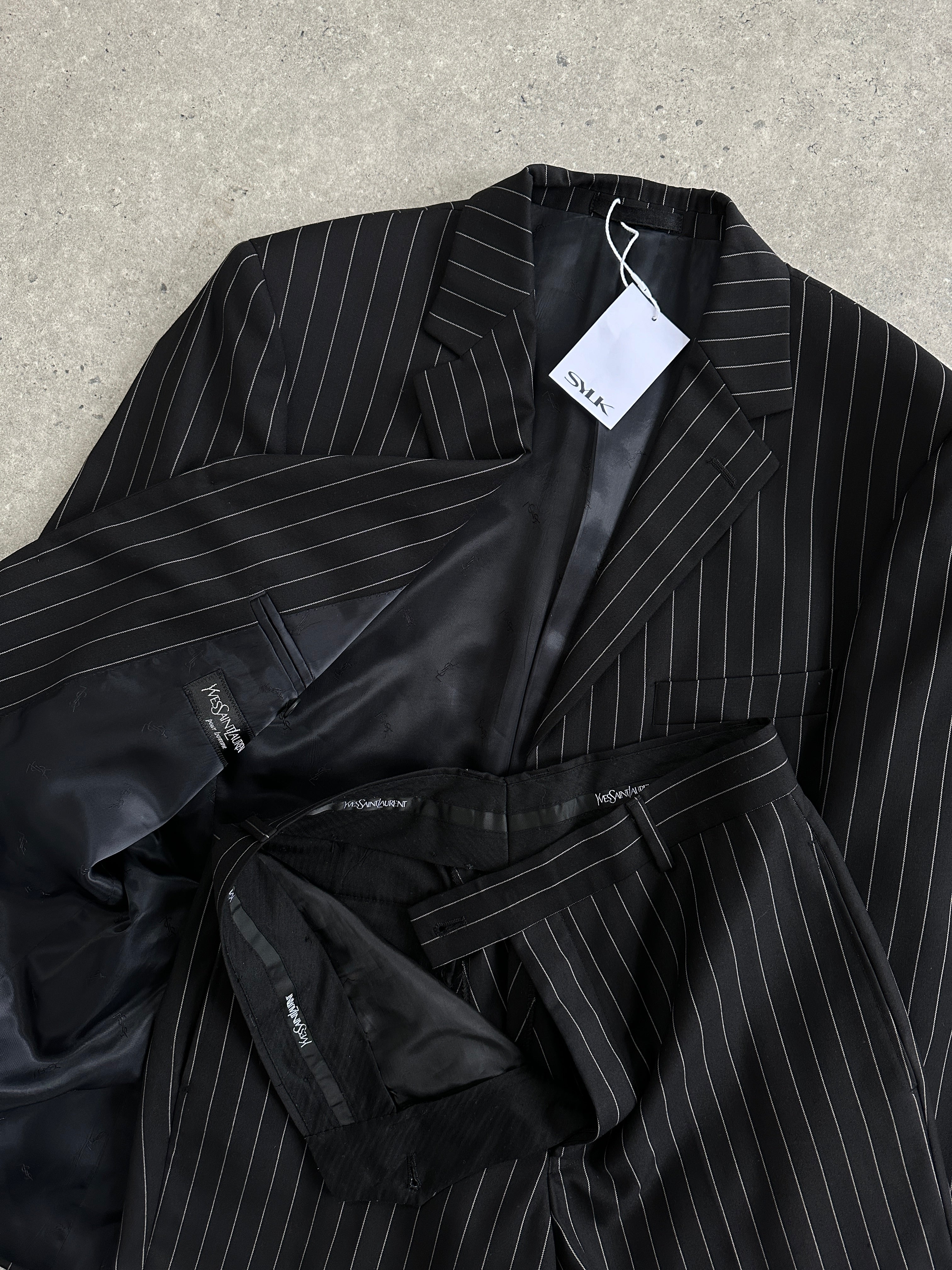 Yves Saint Laurent pour homme pinstripe pure wool single-breasted suit, size 38S/W28, displayed on a hanger.