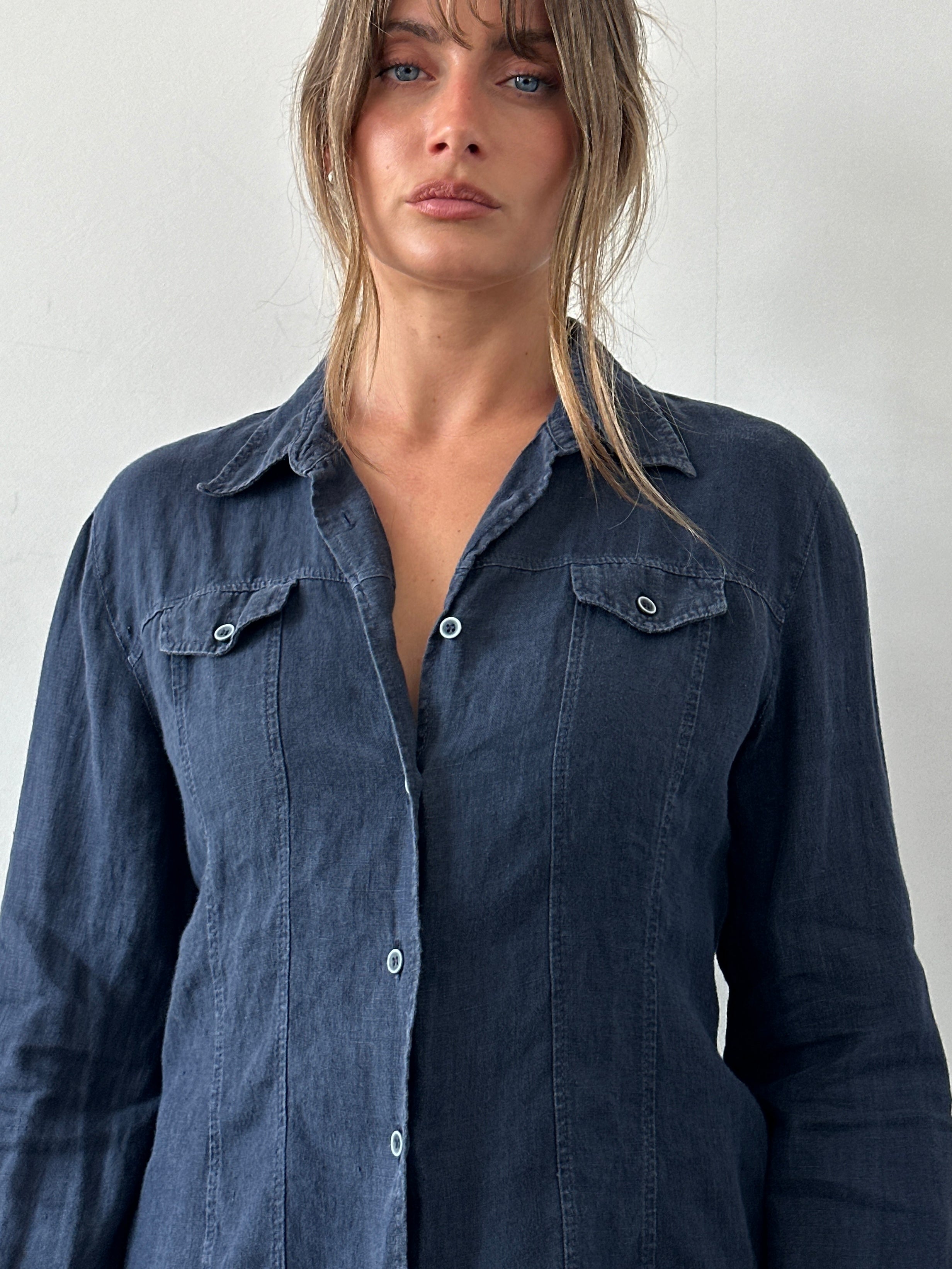 Armani Jeans pure linen fitted shirt in light color, displayed on a hanger, showcasing its collar and button details.