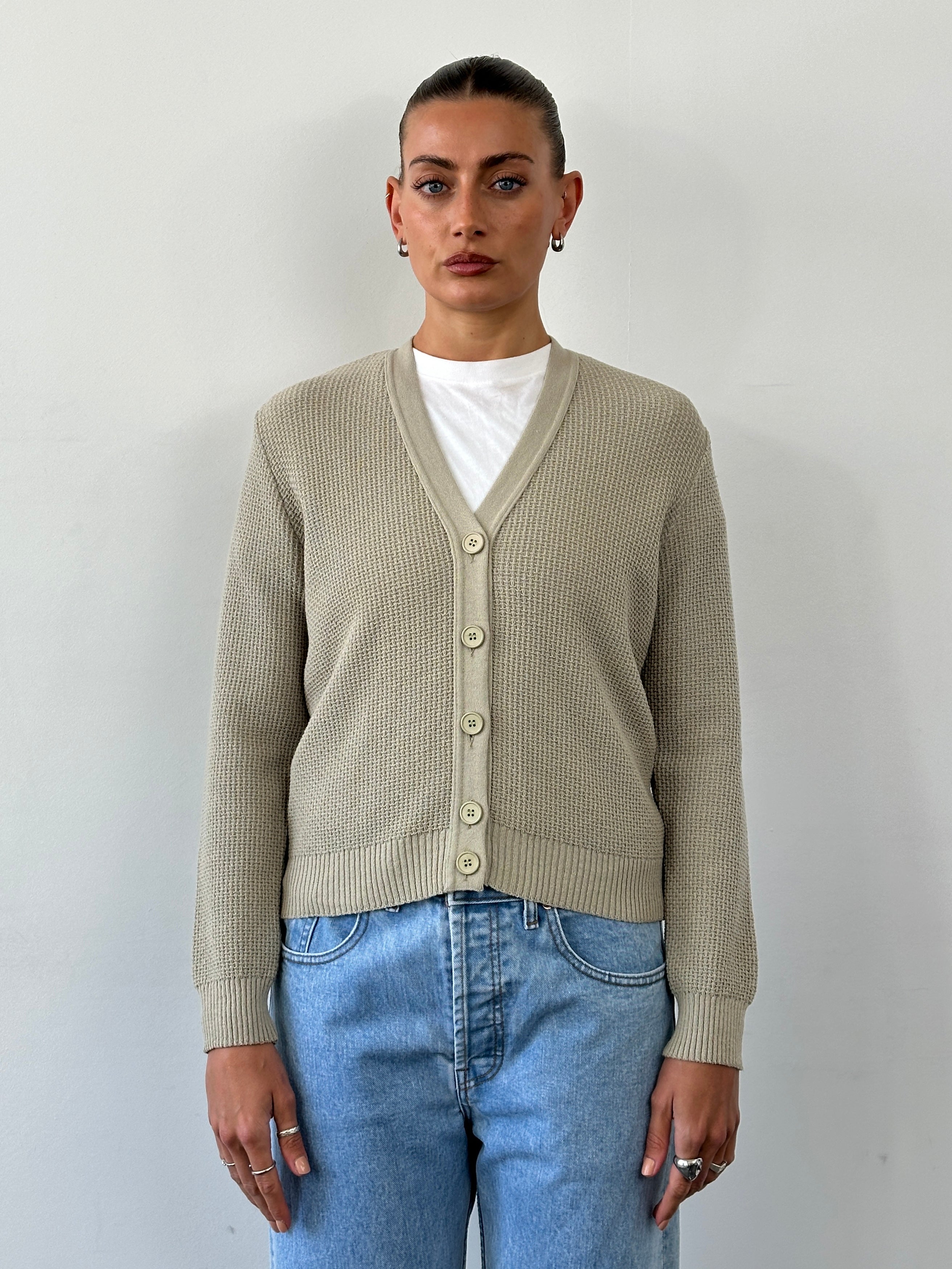Vintage pure wool knitted cardigan in size S, featuring a classic design and soft texture, perfect for cozy style.