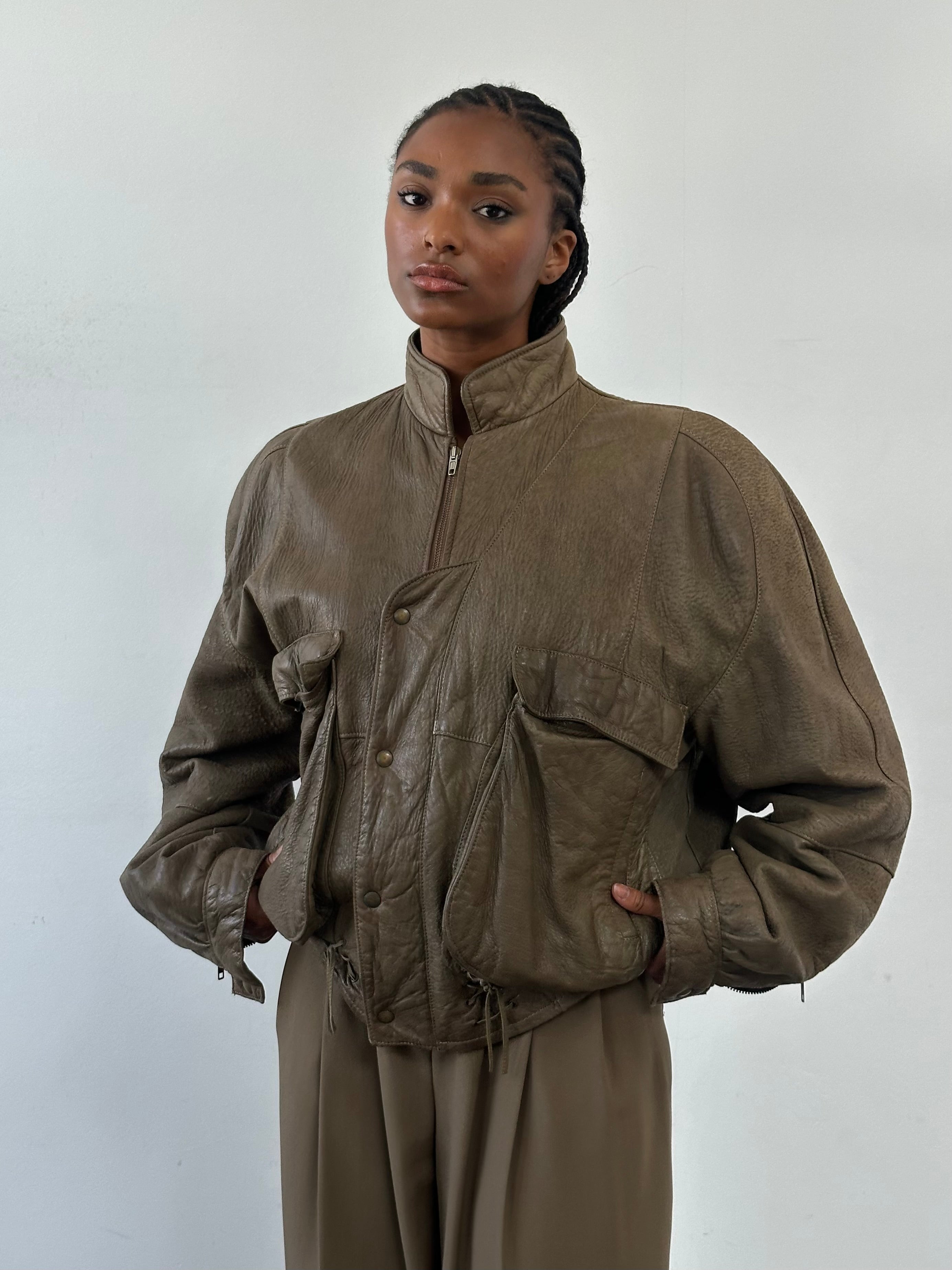Vintage 1980s leather moto jacket in size large, featuring classic design and aged leather detailing.
