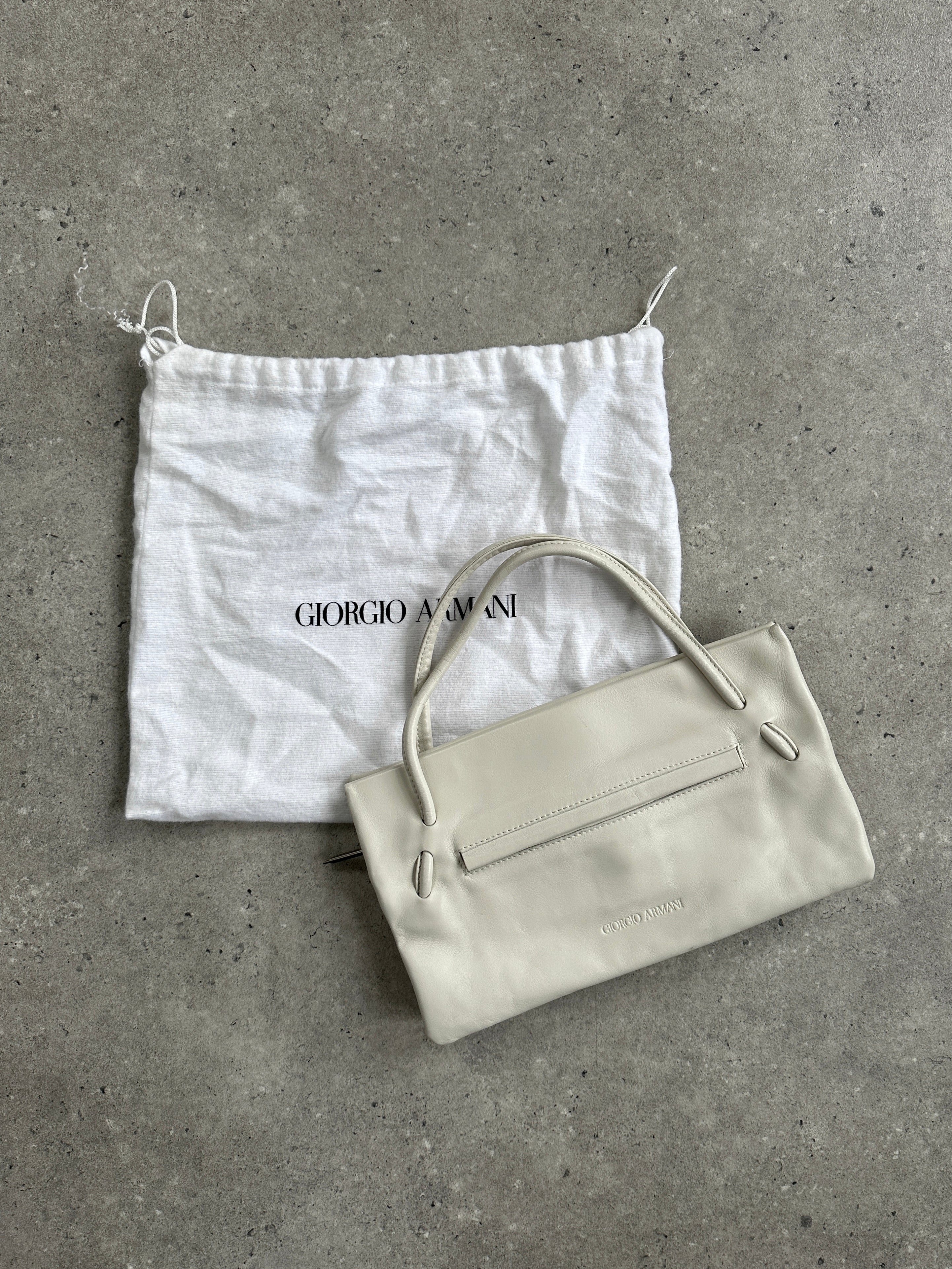 Giorgio Armani Le Collezioni embossed logo handbag with structured shape and elegant design, featuring signature branding details.