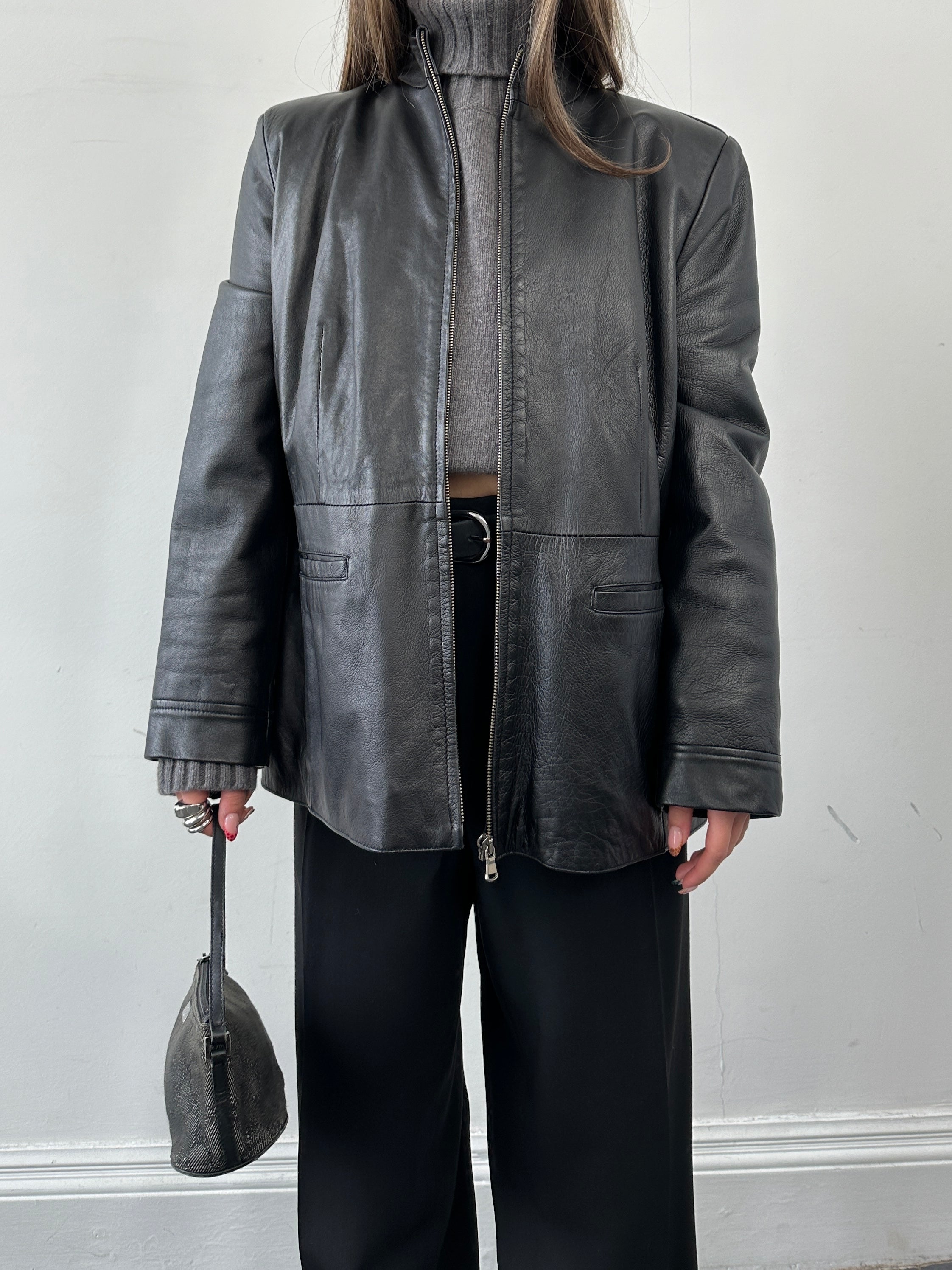Vintage Italian minimal leather jacket in XS/S, showcasing sleek design and classic craftsmanship with smooth leather finish.
