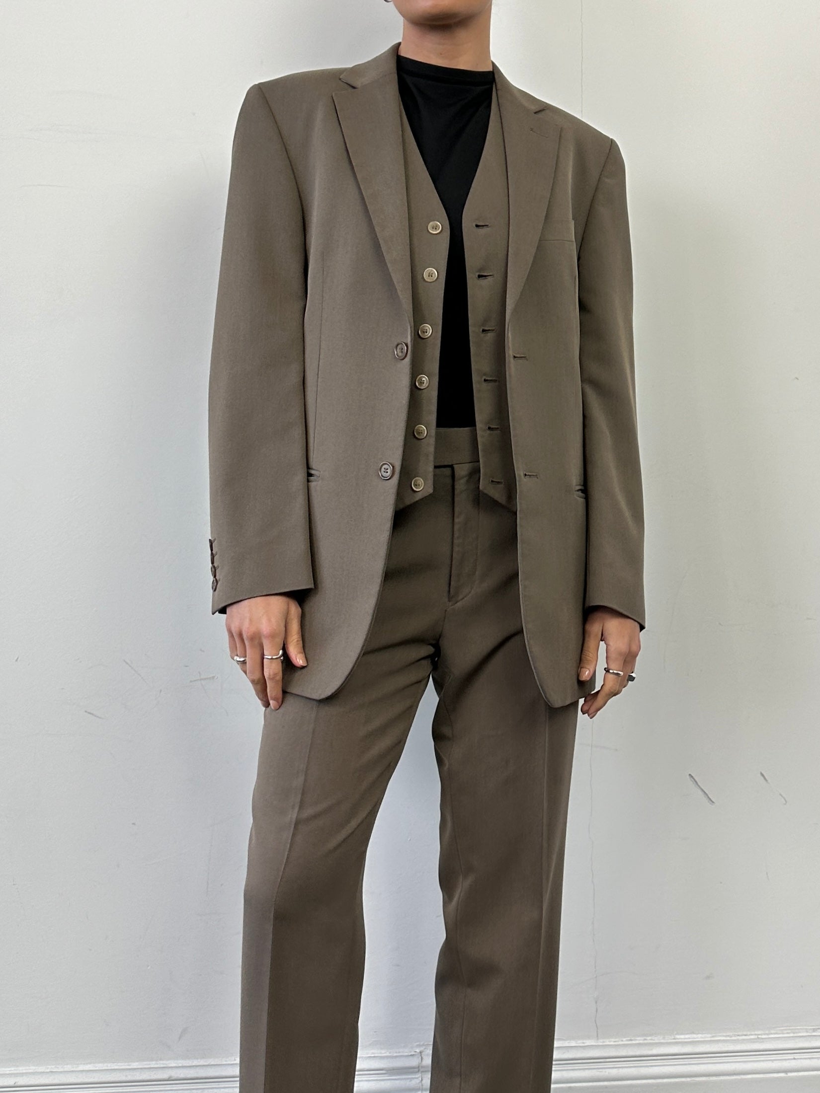 Vintage single-breasted three-piece suit in size 36R/W30, featuring a classic design and tailored fit, displayed on a hanger.