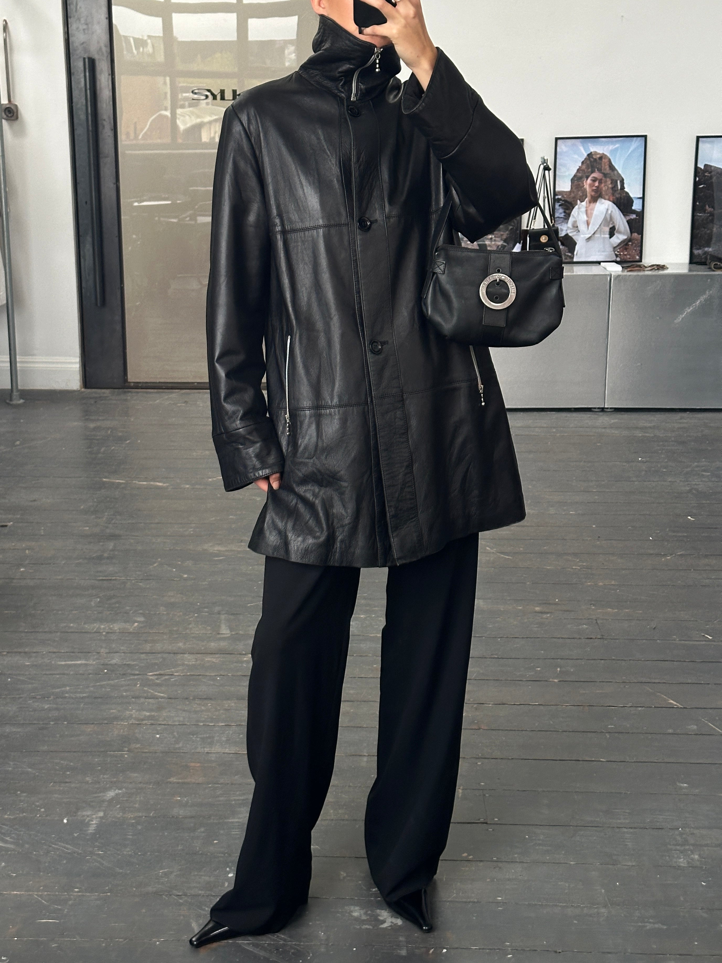 Conbipel 1990s smooth leather high neck coat in size L/XL, featuring a sleek design and high collar, on a hanger.