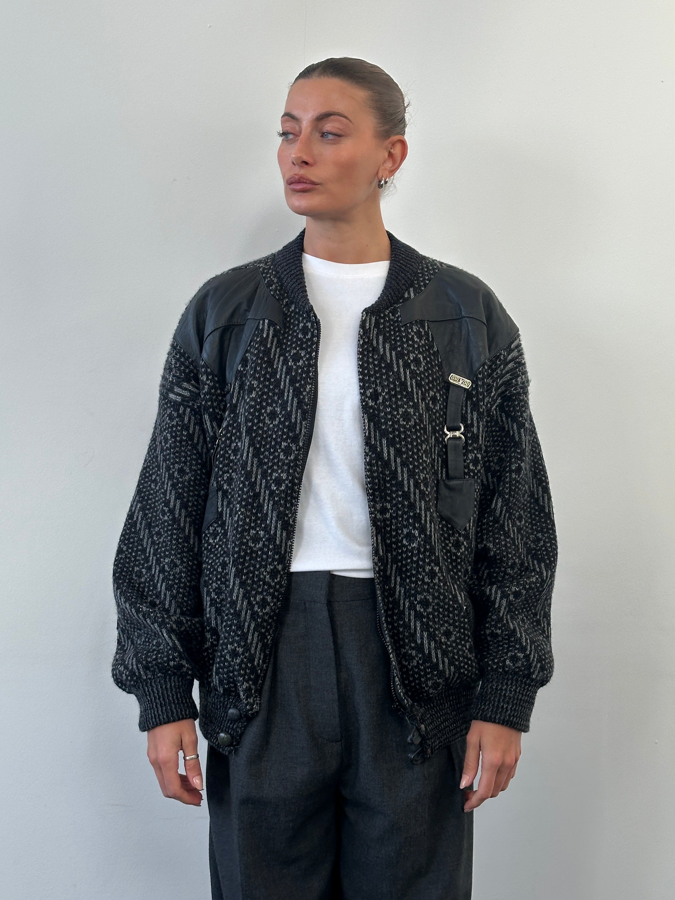 Vintage 1980s wool print knit bomber jacket in XL with colorful geometric pattern and classic ribbed cuffs and collar.