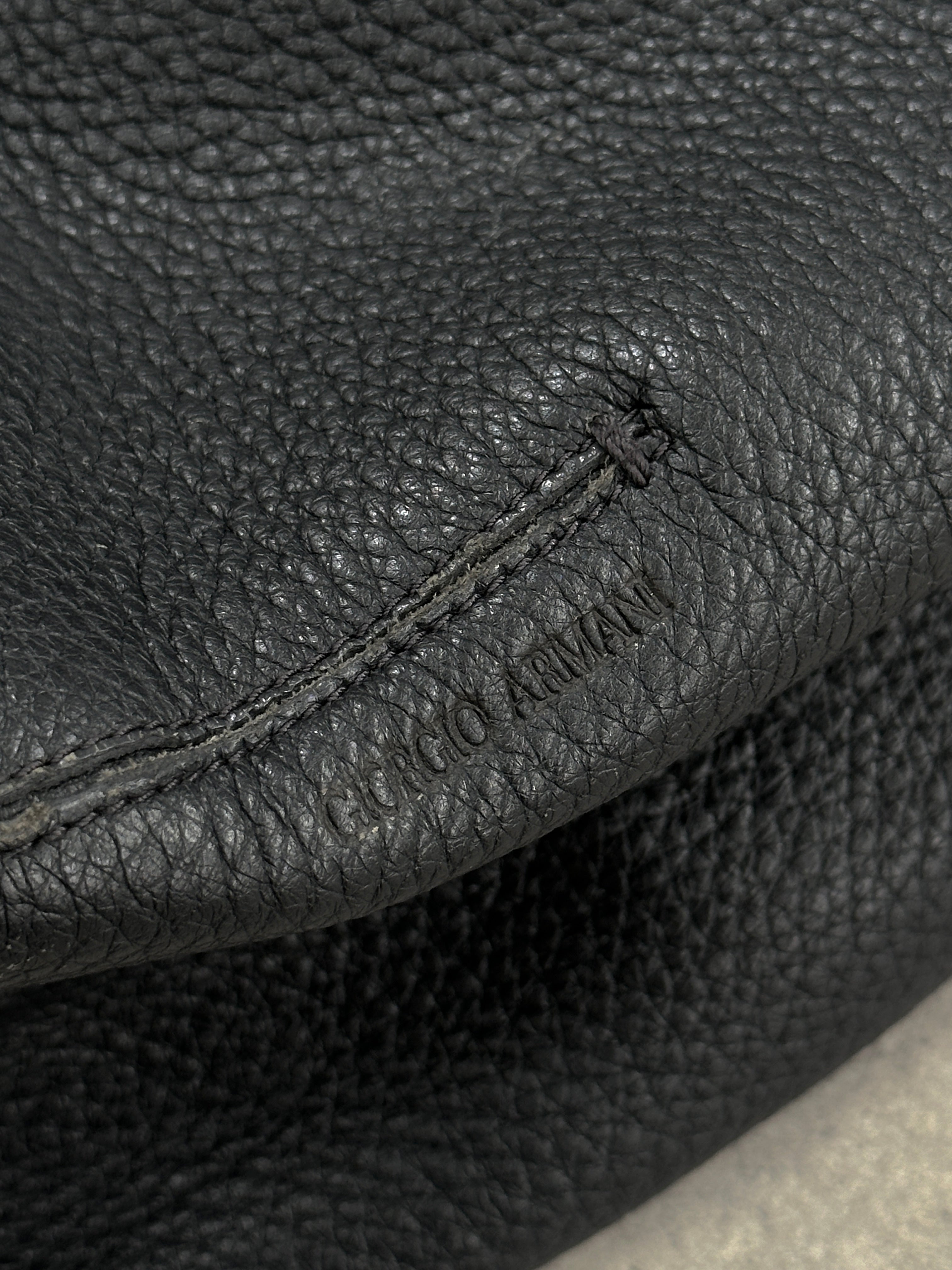 Giorgio Armani 2000s leather hobo shoulder bag with slouchy design and subtle stitching, crafted from smooth brown leather.