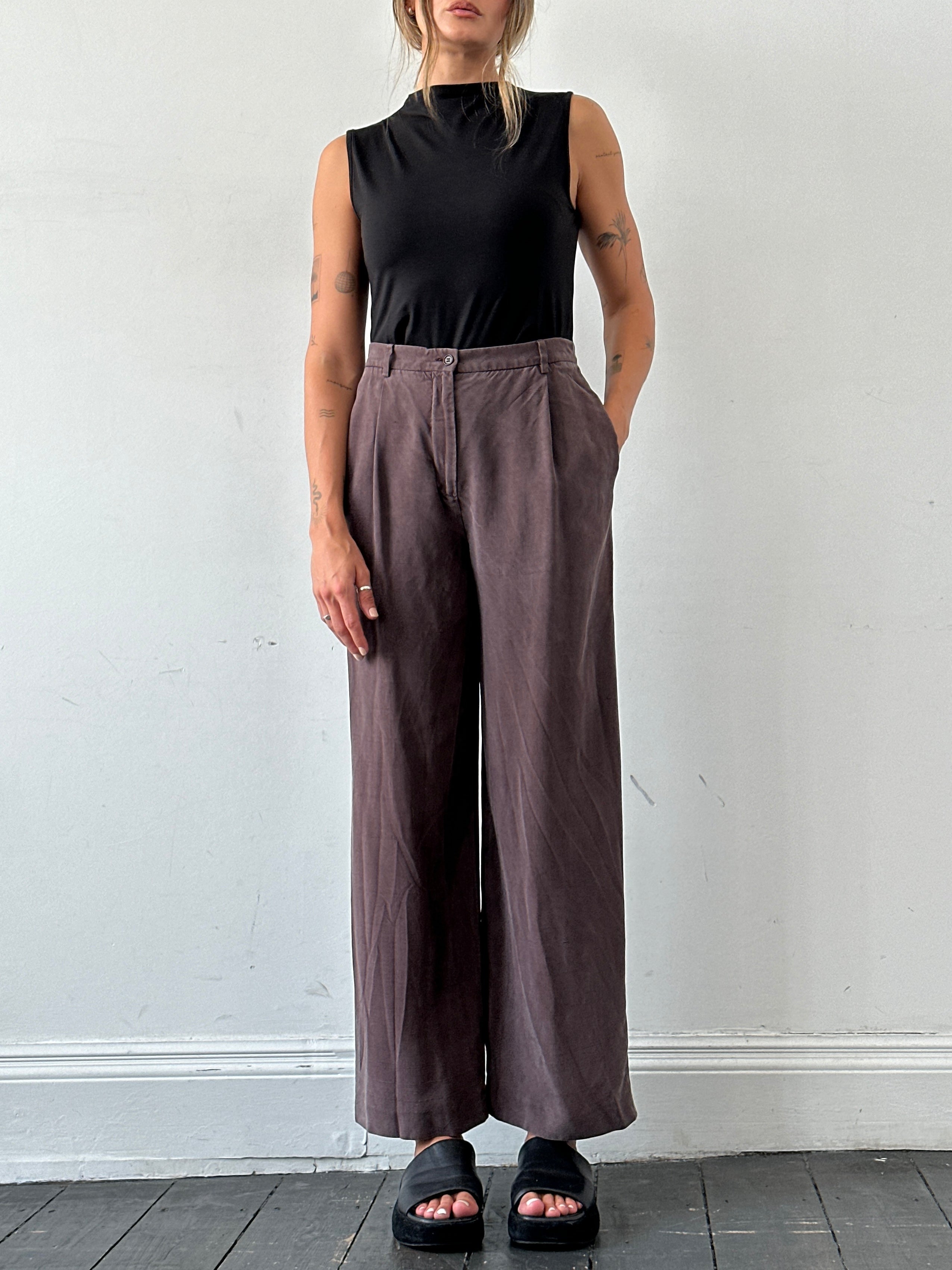 Max Mara pure silk wide-leg high-waisted trousers in white, showing the flowing fabric and tailored fit.