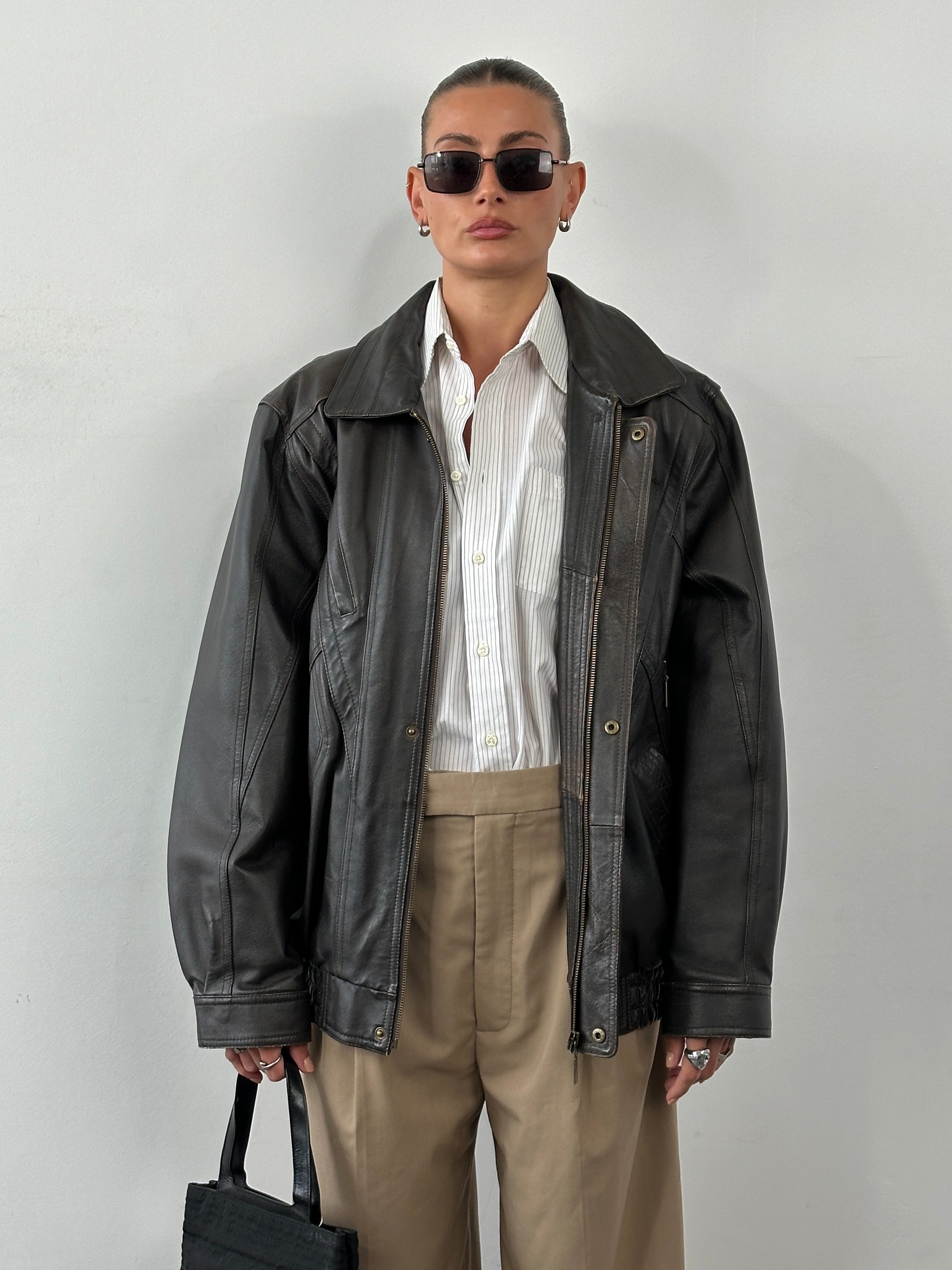 Vintage leather blouson bomber jacket in XL size, featuring classic design with a worn-in leather texture and ribbed collar and cuffs.