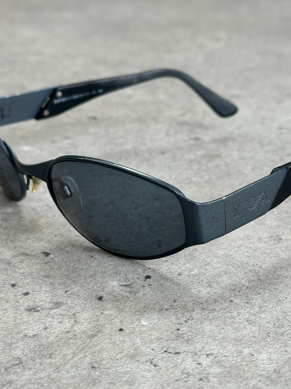 Emporio Armani 1990s oval logo sunglasses with dark lenses and sleek black frame, stylish vintage design.