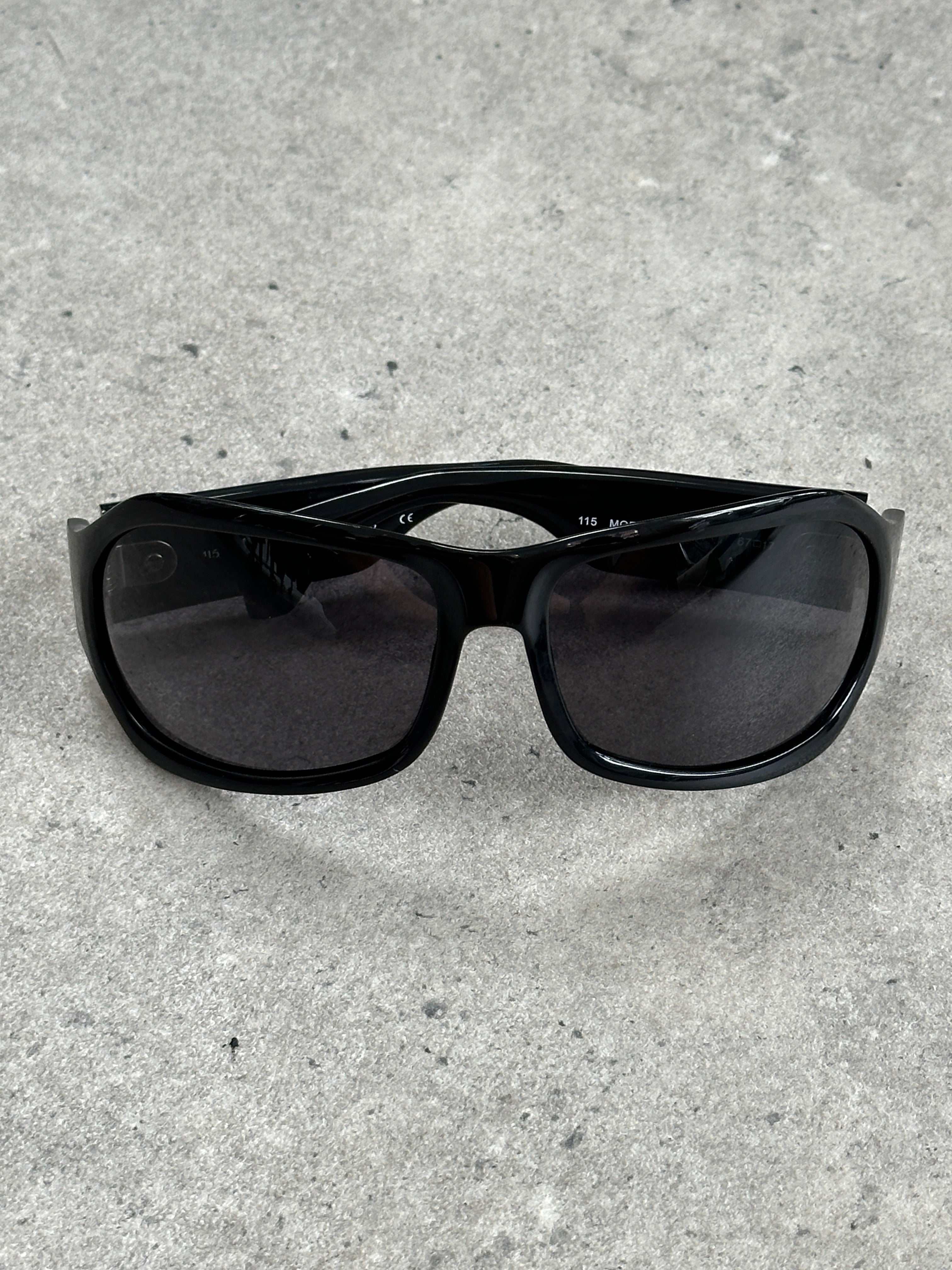 Vintage 2000s oversized shield sunglasses with bold black frames and dark lenses, stylish and iconic eyewear from the vintage brand.