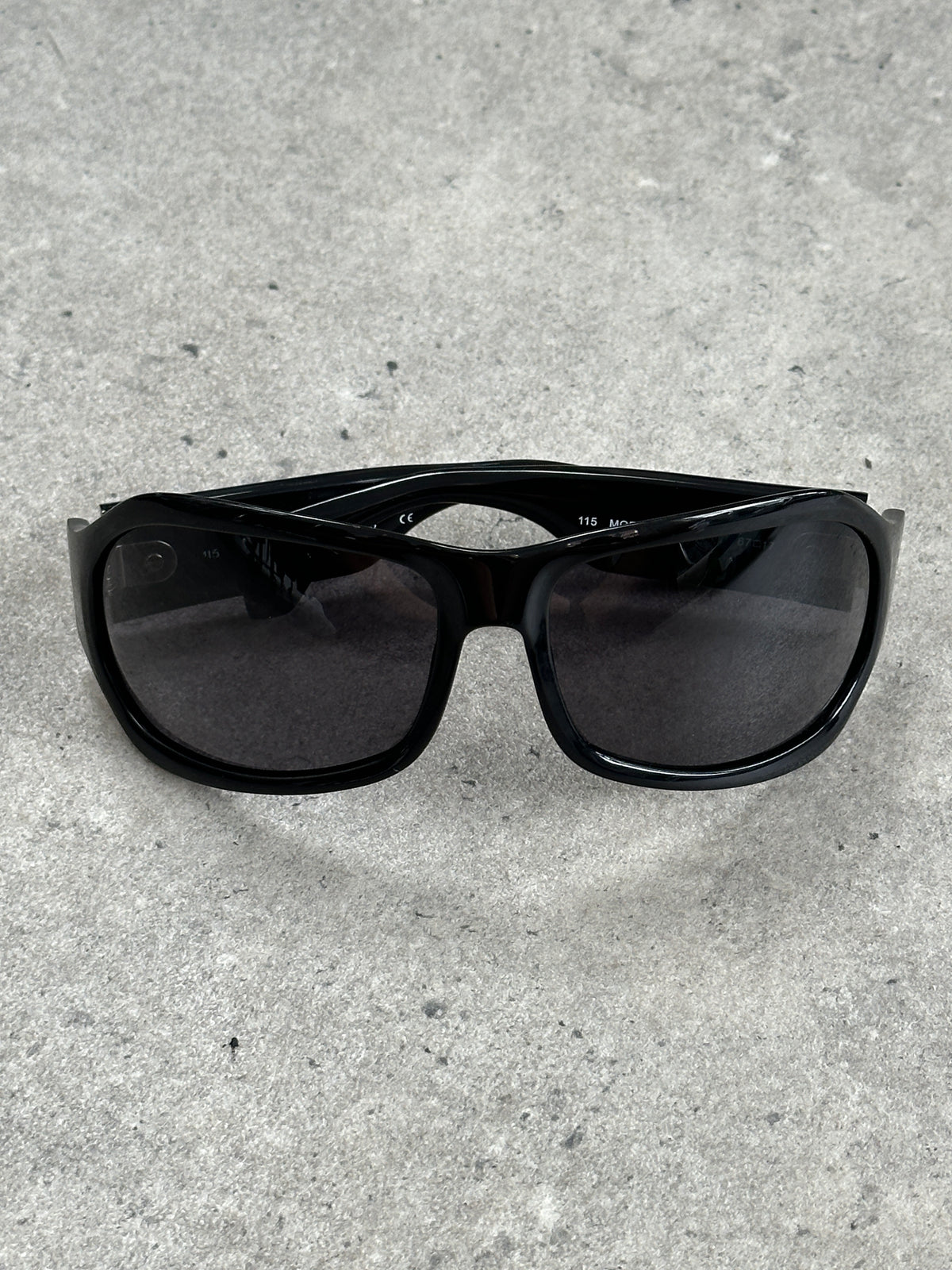 Vintage 2000s oversized shield sunglasses with bold black frames and dark lenses, stylish and iconic eyewear from the vintage brand.