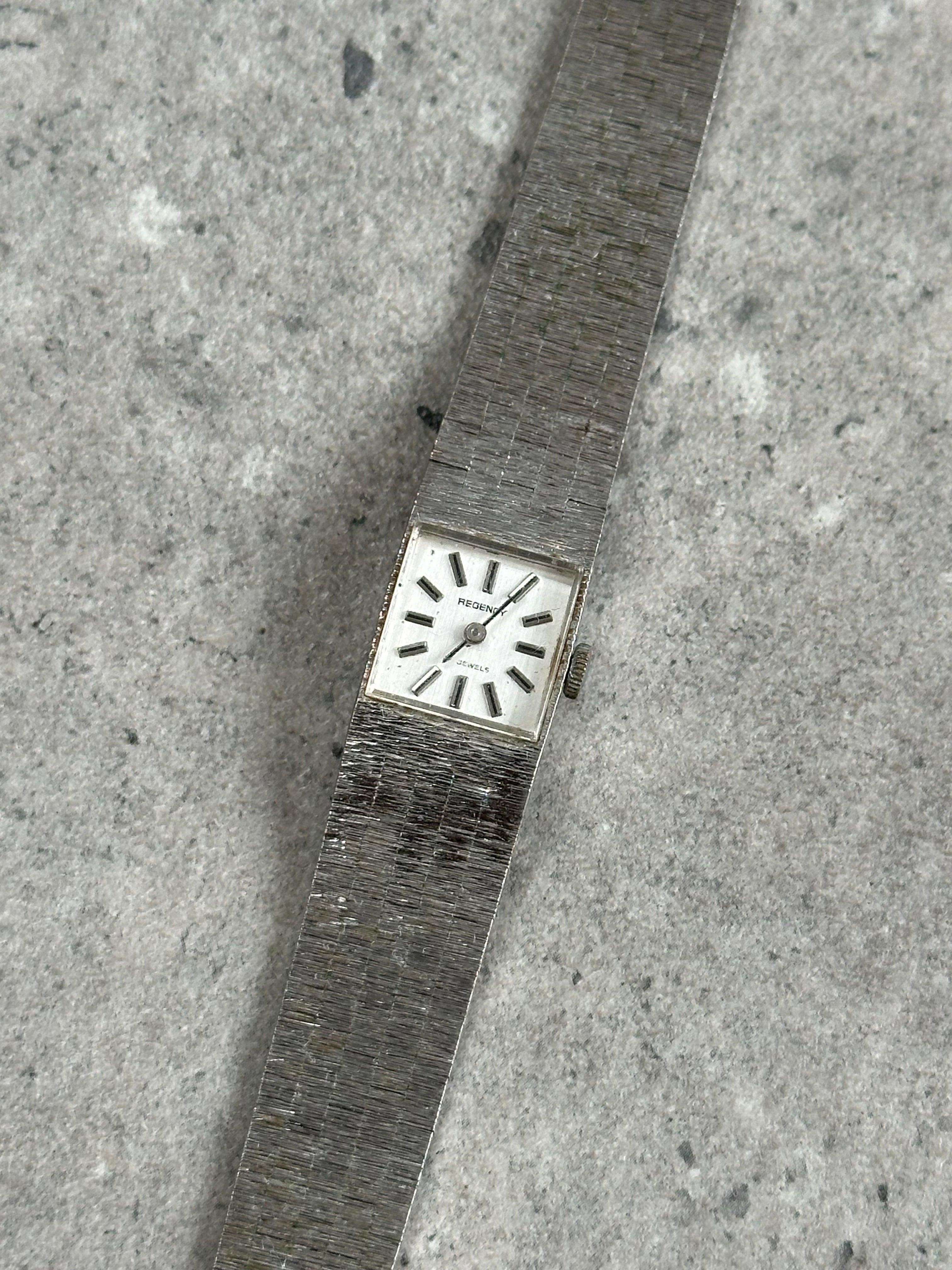 Vintage stainless steel square dial watch from the 1970s with a classic design and metal strap.