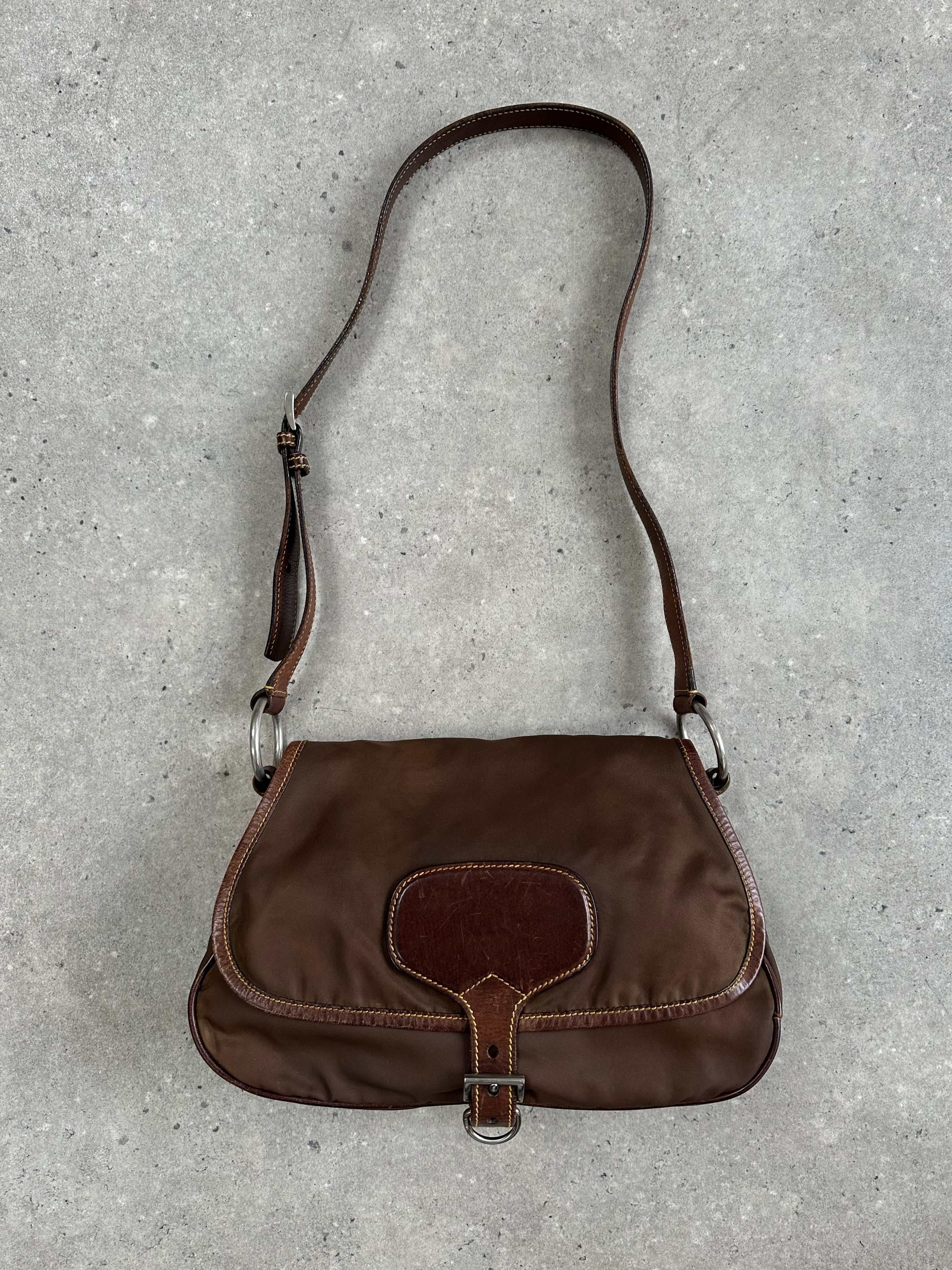 Prada 1990s nylon crossbody bag with adjustable strap and sleek design, featuring the iconic Prada logo on the front.