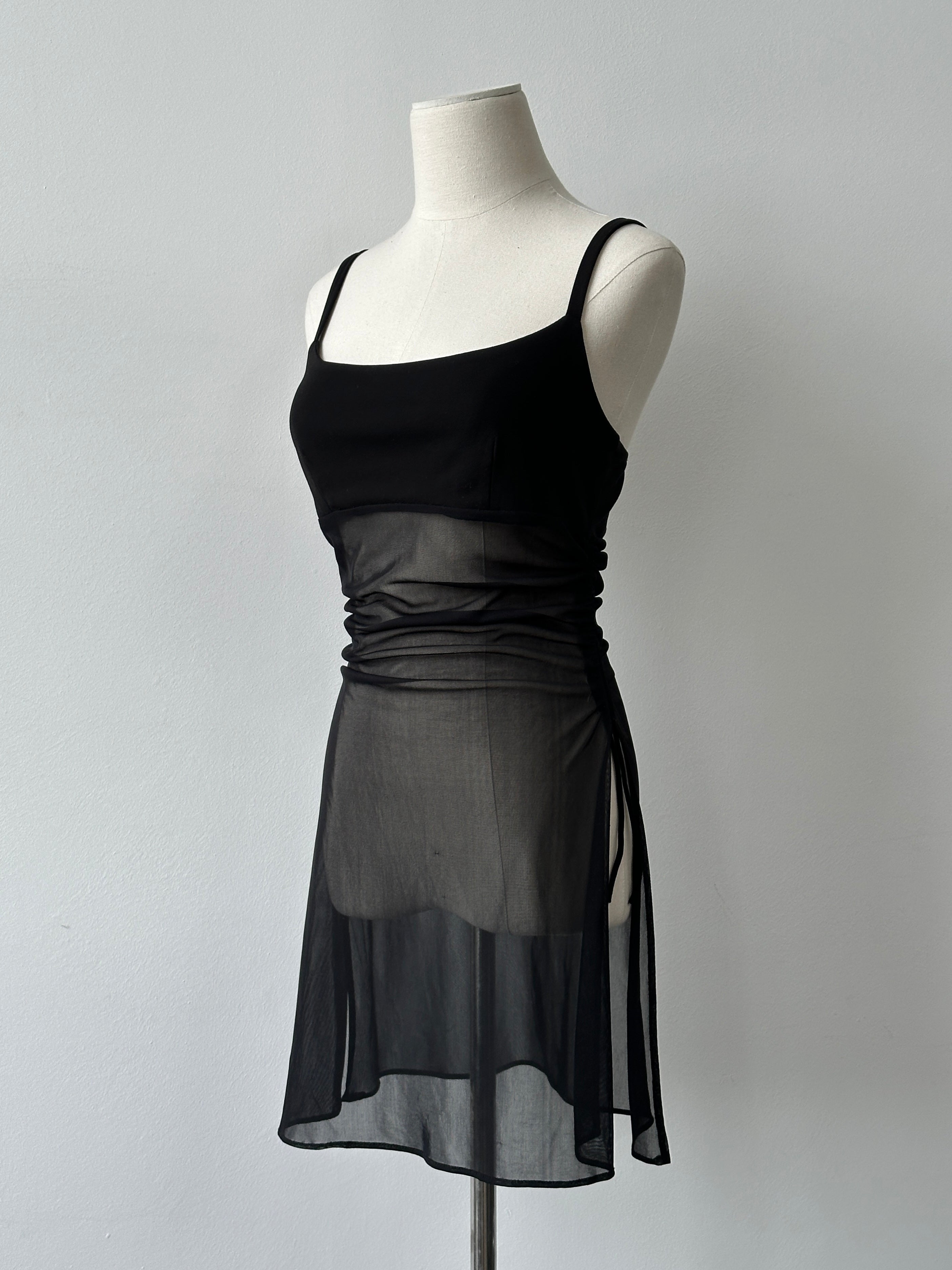 Vintage French 1990s sheer sleeveless top, soft fabric, classic design, displayed on a hanger with subtle details.