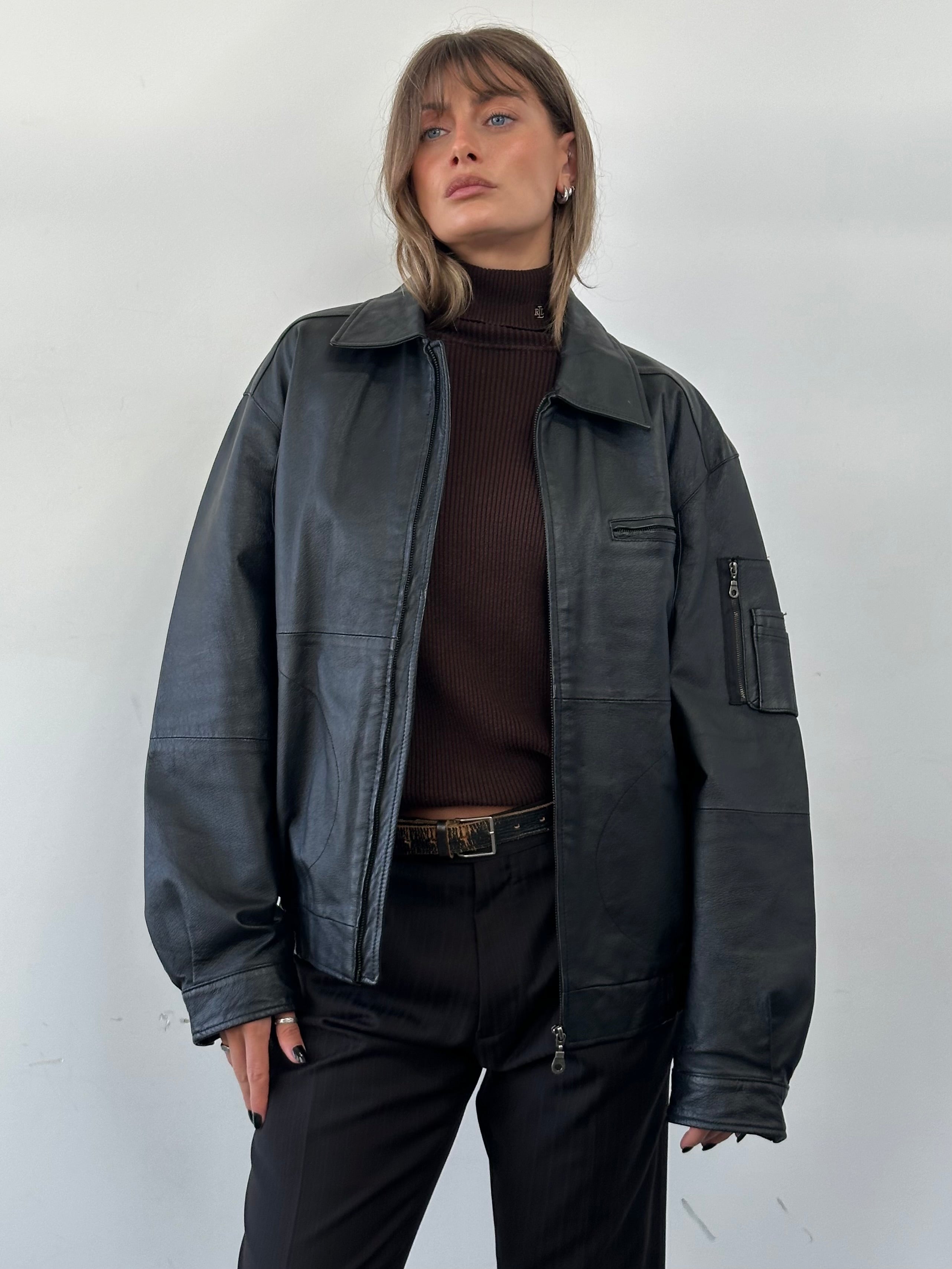 Vintage leather bomber jacket in XL size, featuring classic design with distressed finish and ribbed cuffs.
