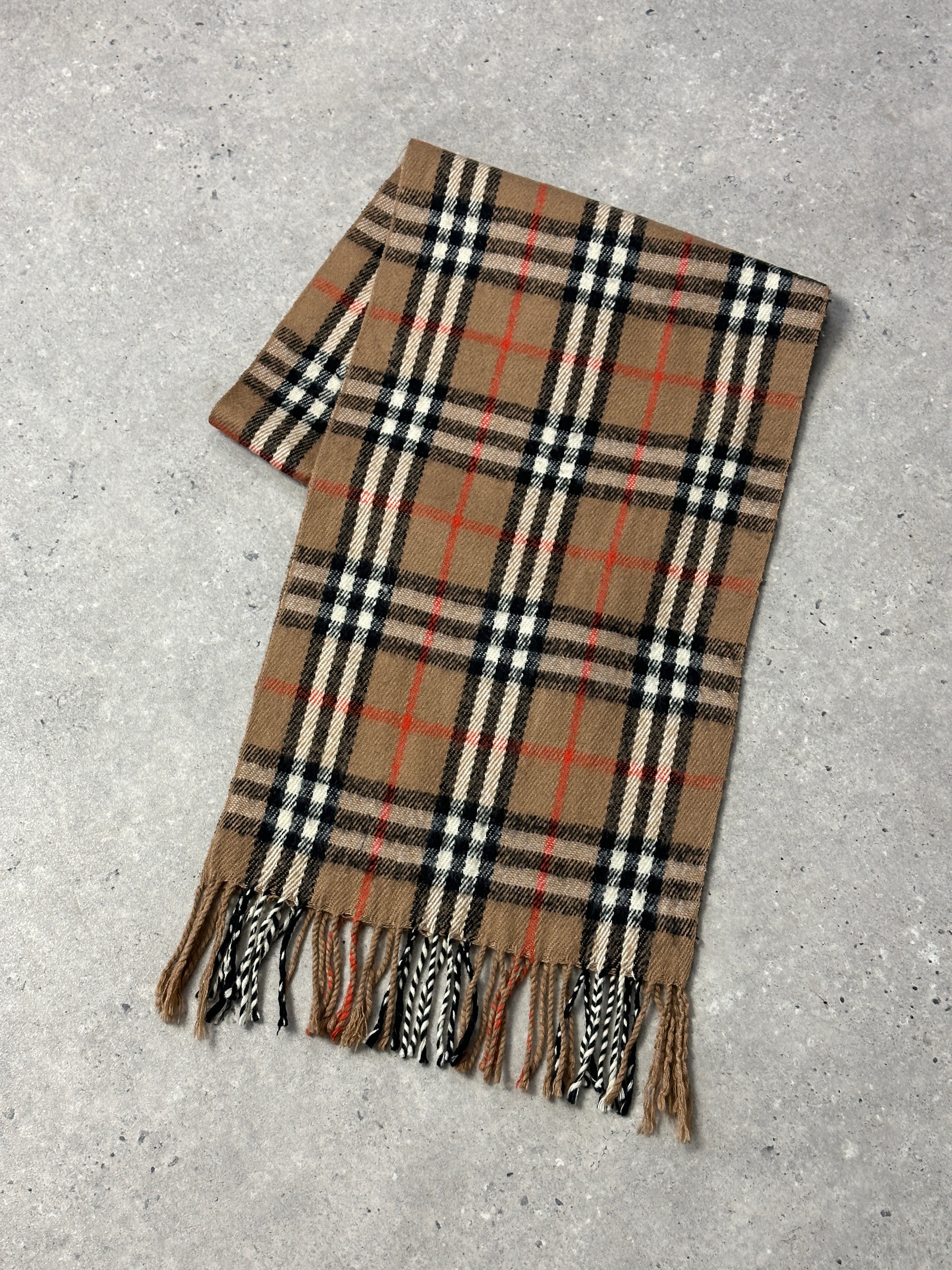 Vintage Nova Check Scarf showing a classic plaid pattern in red, black, and white with fringed edges.