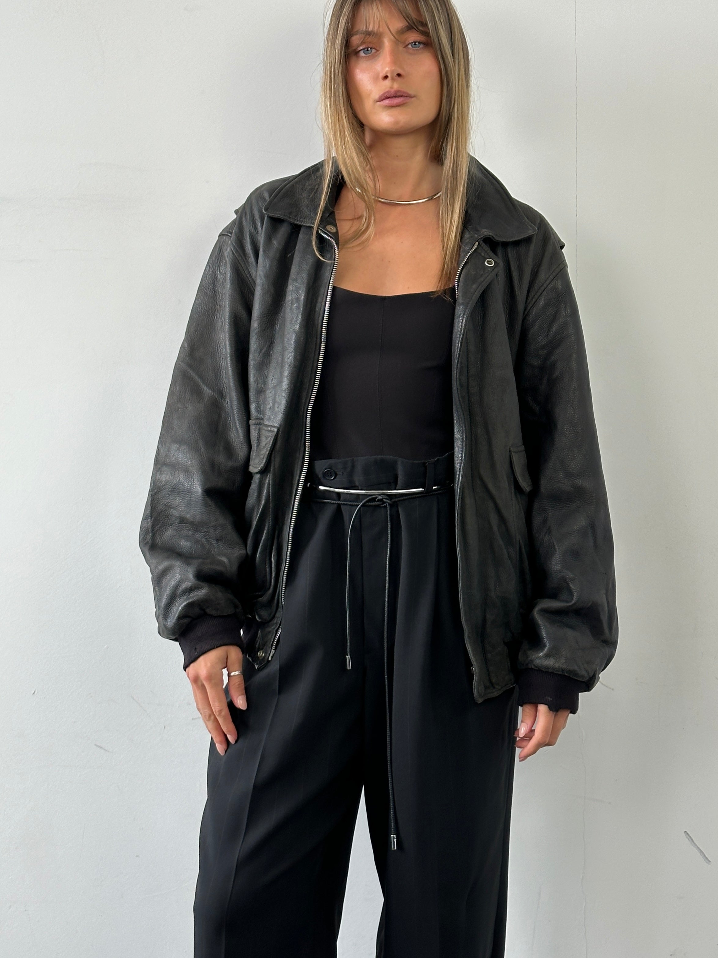 Vintage Italian aged leather bomber jacket in XL, featuring classic design, distressed finish, and detailed stitching.