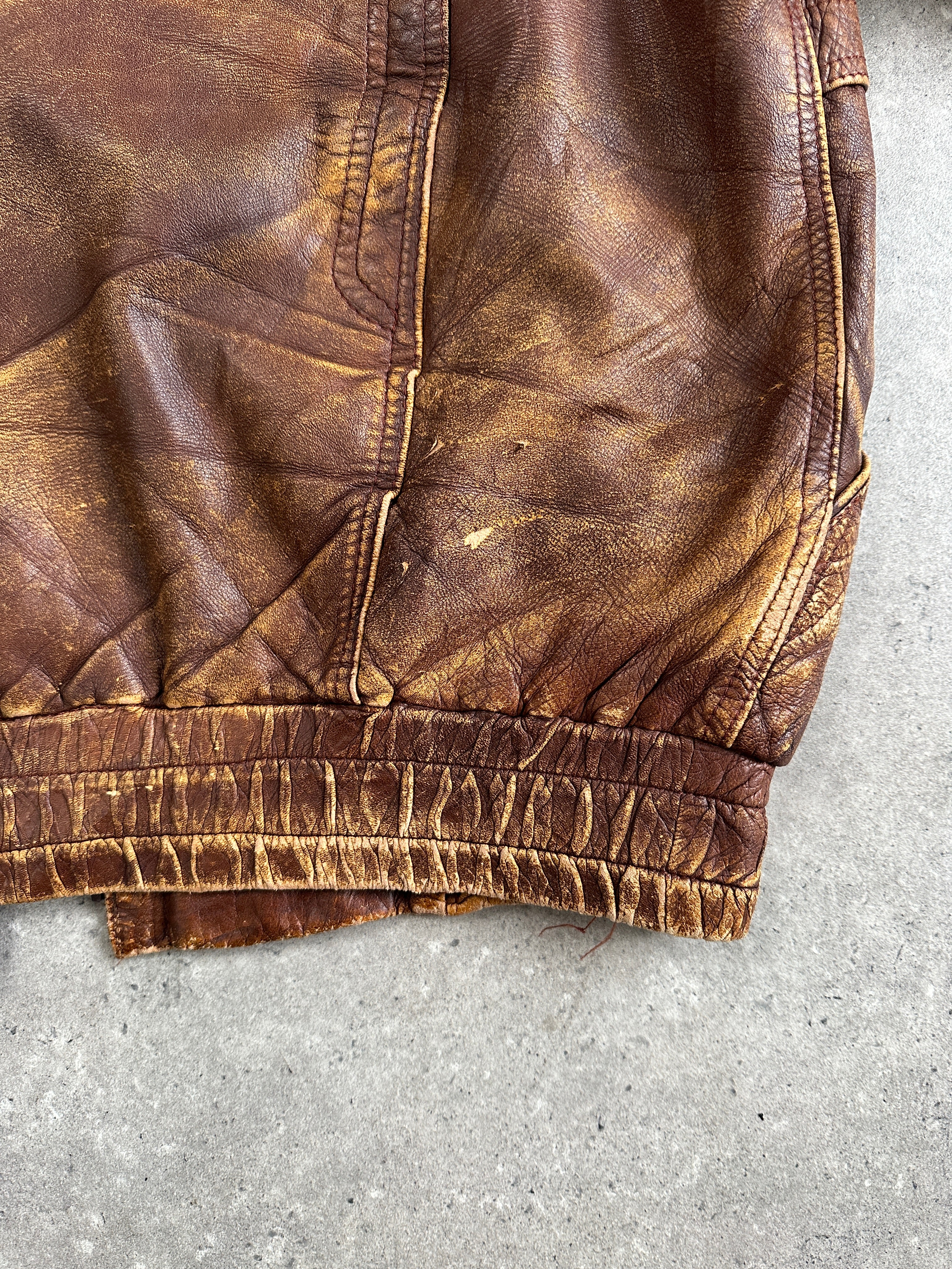 Vintage brand 1990s aged leather bomber jacket in size XL, showing distressed leather and classic bomber style.
