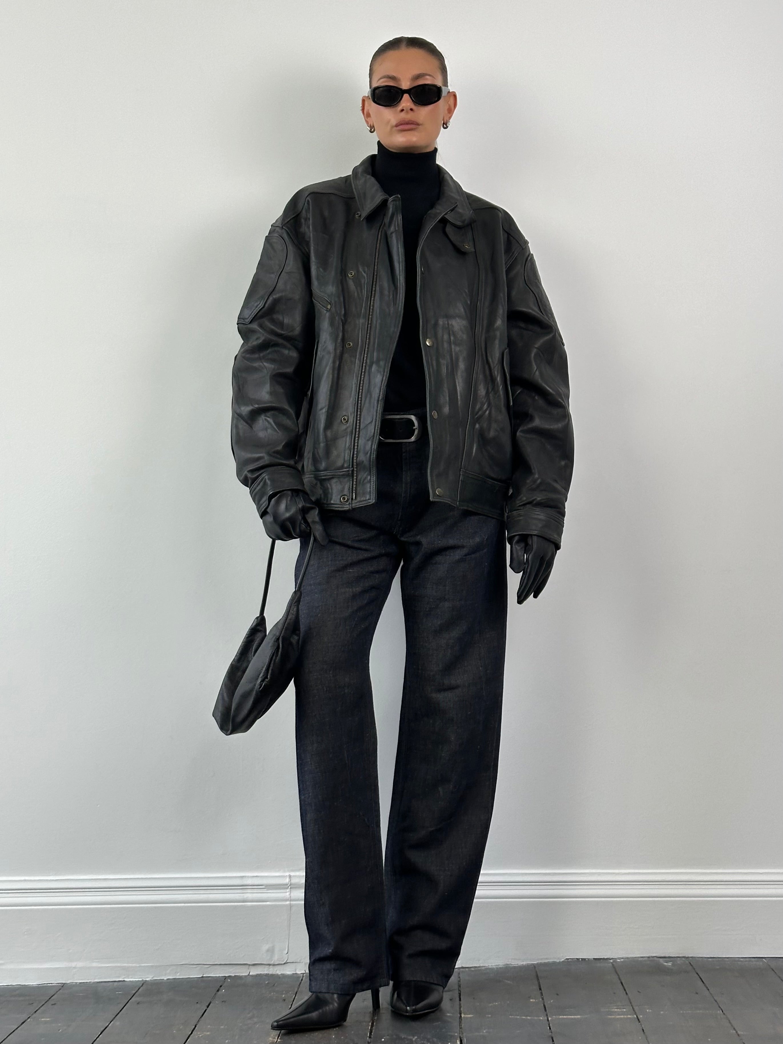 Vintage leather jacket in size XL, featuring classic design with detailed stitching and a rugged, timeless look.