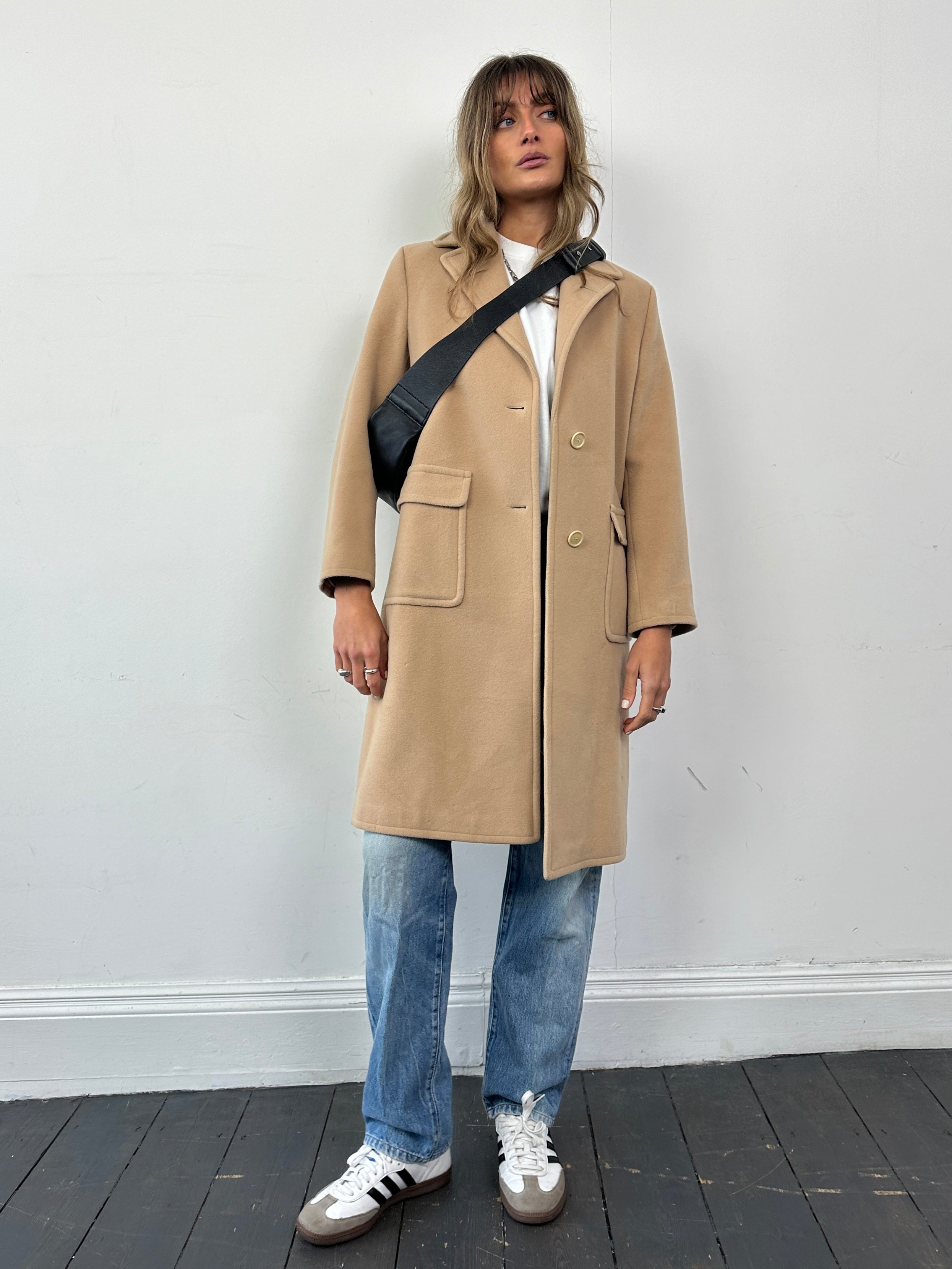 Hugo Boss pure wool single-breasted coat in size small, tailored design, shown in a neutral color on a hanger.