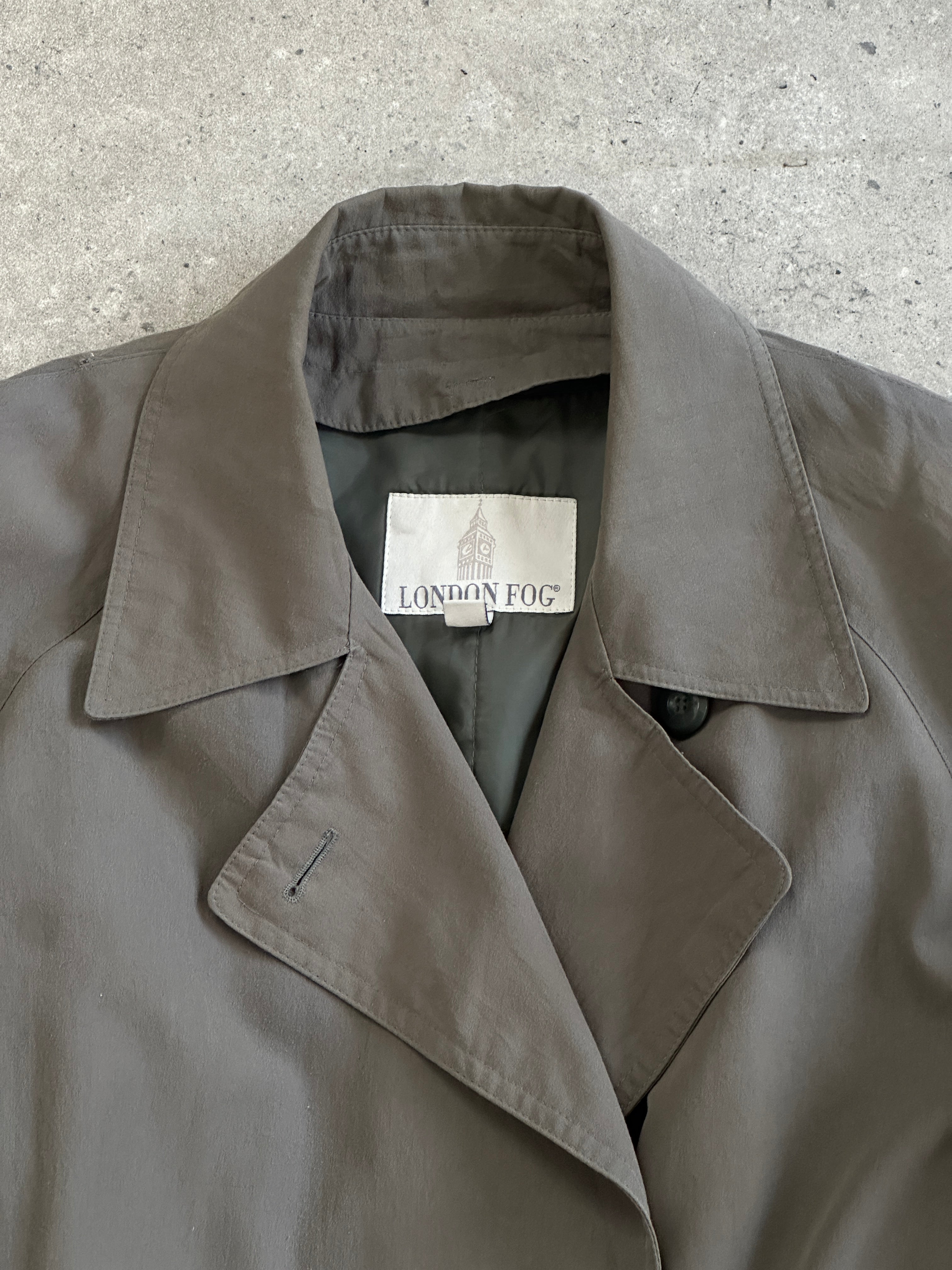 London Fog double-breasted trench coat in size small/medium, featuring classic beige fabric and stylish collar detail.