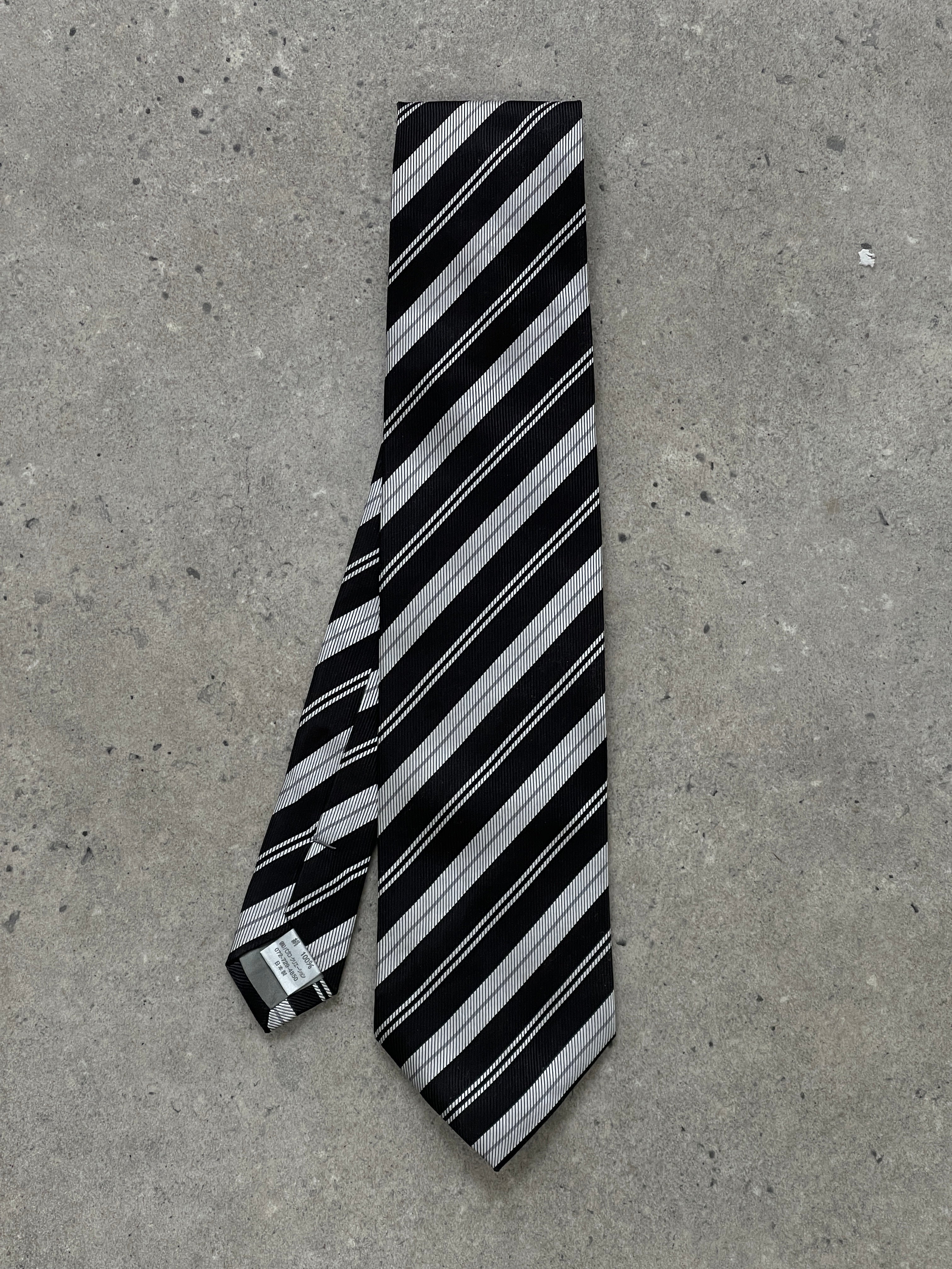 Vintage Japanese 2000s pure silk diagonal stripe tie, showcasing elegant craftsmanship and classic pattern in natural light.