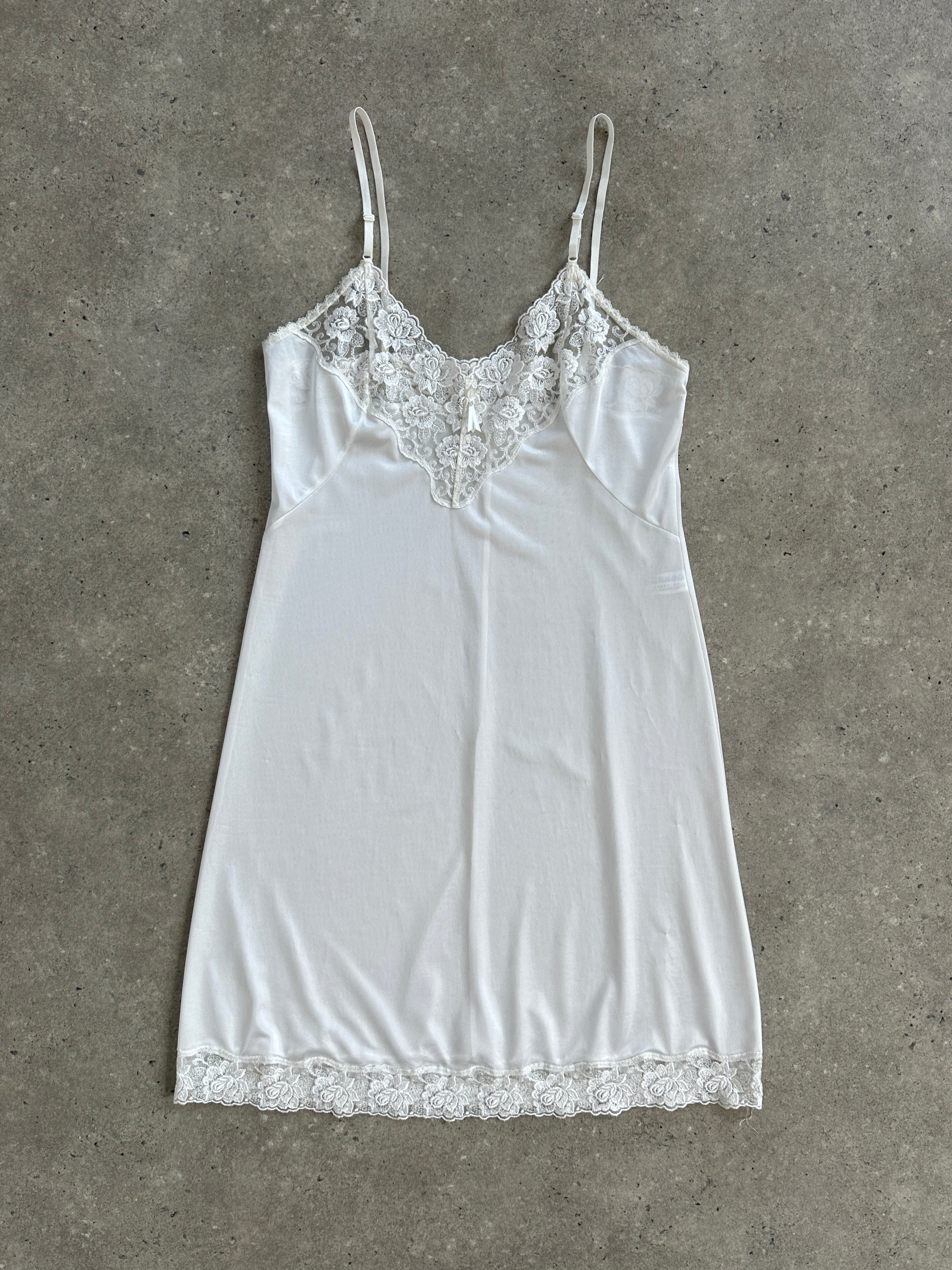 Vintage 1990s lace sheer mini slip dress in size small, featuring delicate lace fabric and a vintage-inspired design.