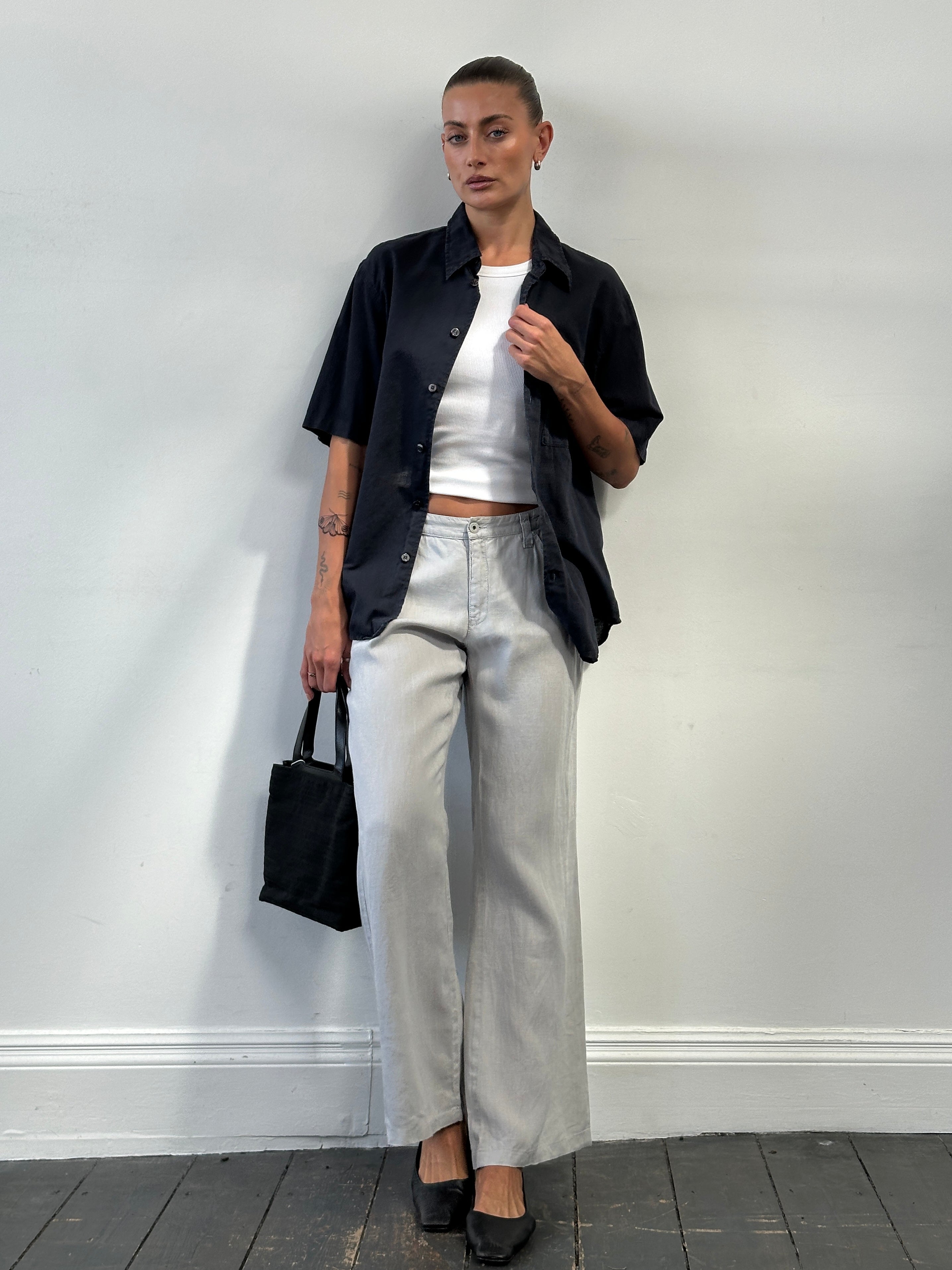 Armani Jeans pure linen flared trousers in size W33, featuring a relaxed fit and stylish design, laid flat on a neutral background.