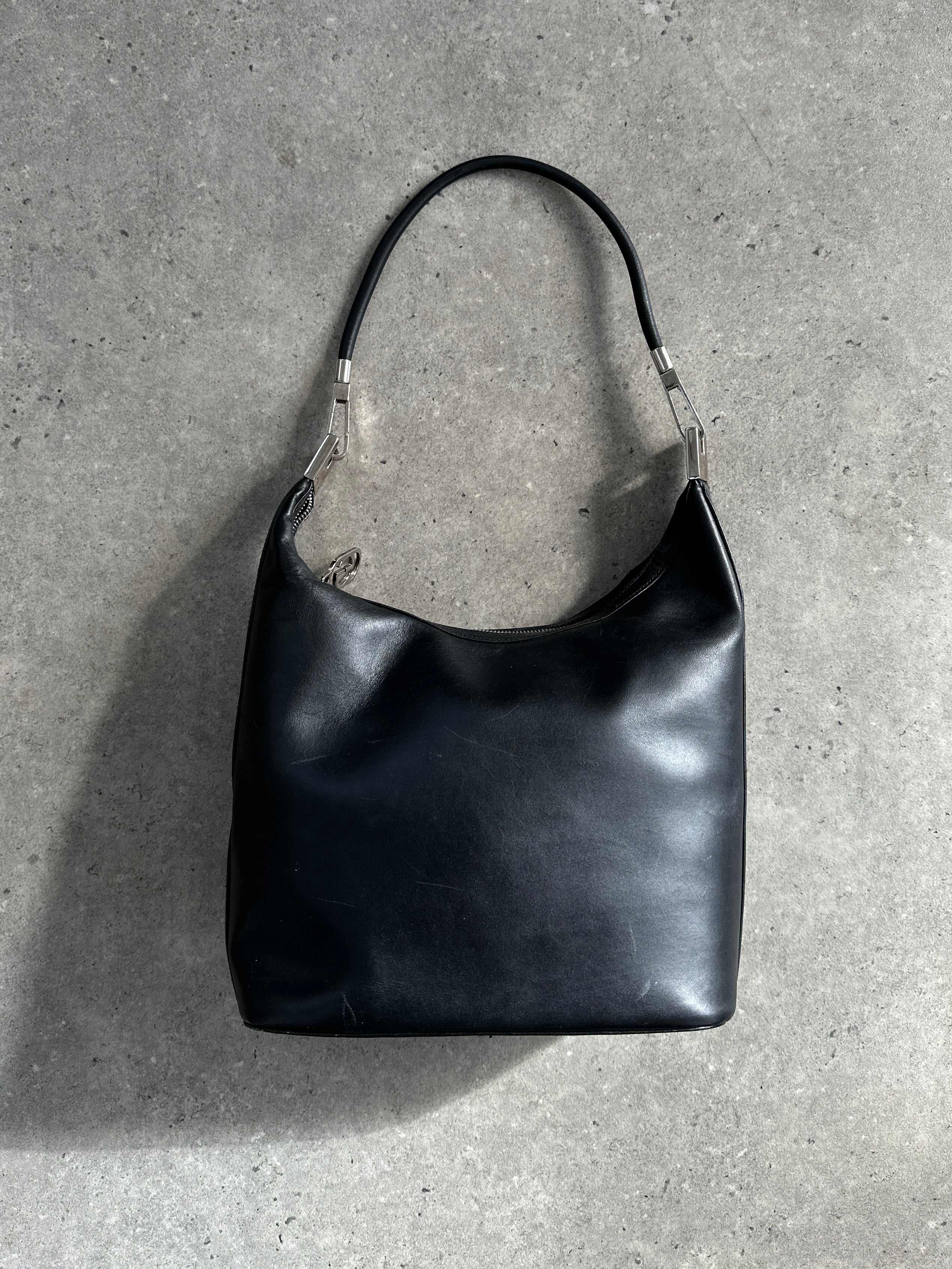 Gucci 1990s Tom Ford GG leather hobo shoulder bag with spacious design and iconic logo details.